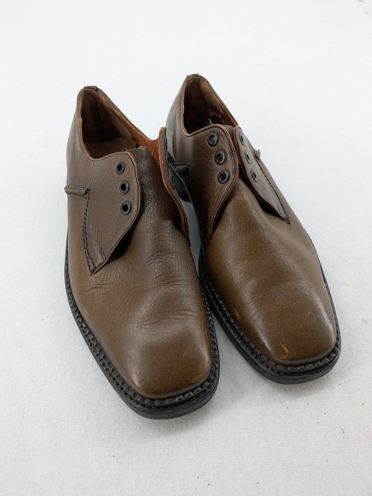 Fonda brown deck shoes genuine leather square toe design with decorative stitching.