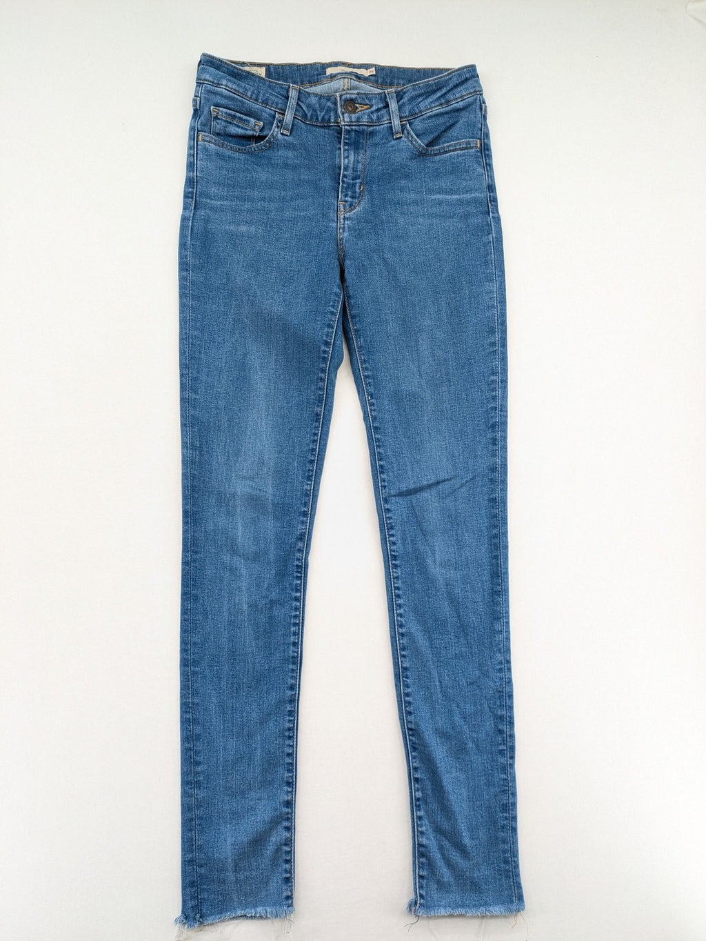Levi's blue skinny jeans with raw hem, classic five-pocket design, and zip fly.