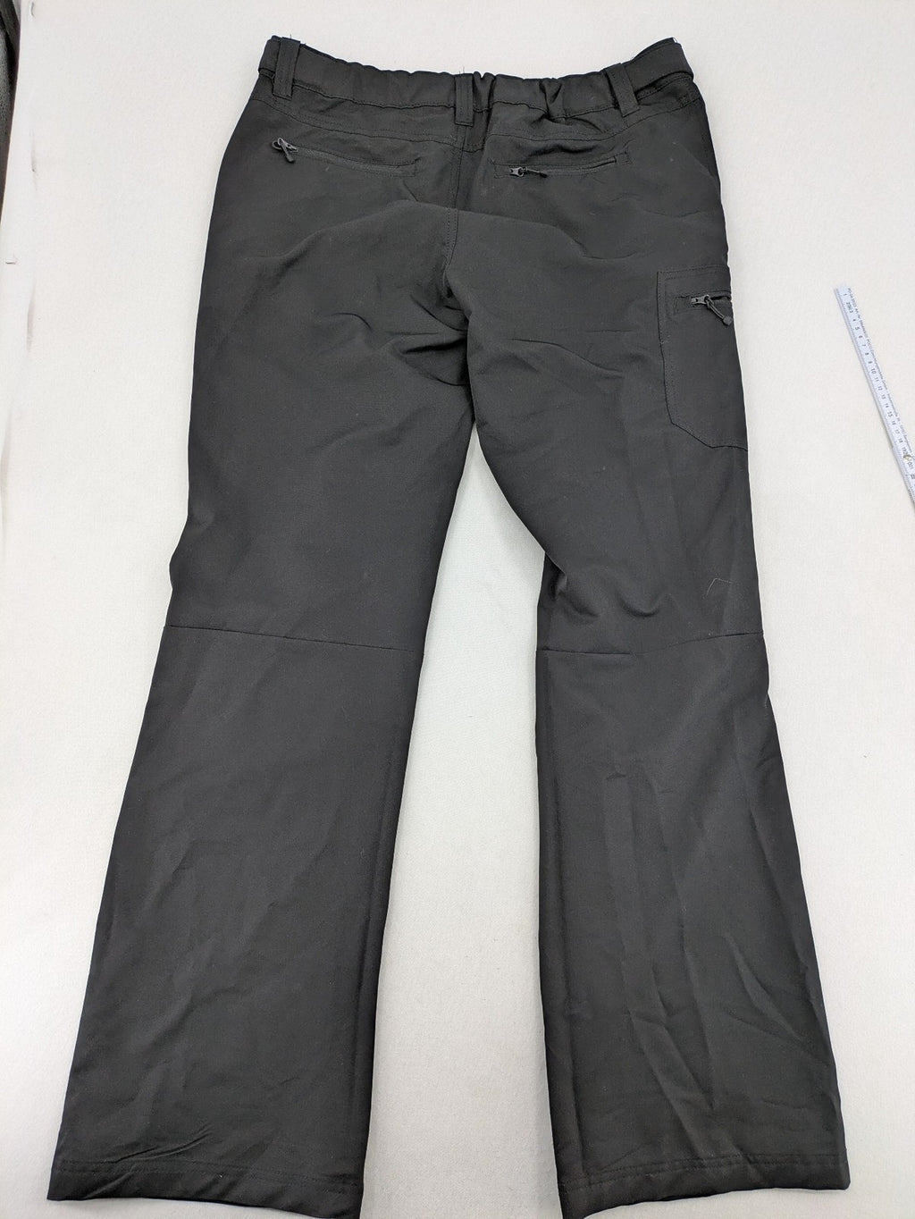 Outdoor grey trekking pants with zippered cargo pockets and durable stretch fabric.