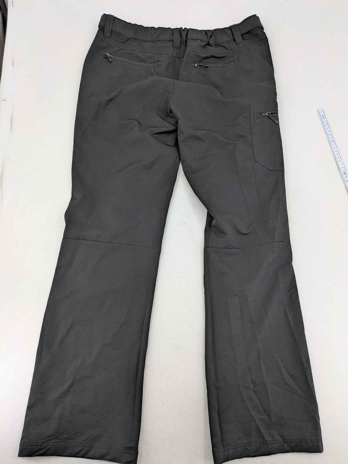 Outdoor grey trekking pants with zippered cargo pockets and durable stretch fabric.