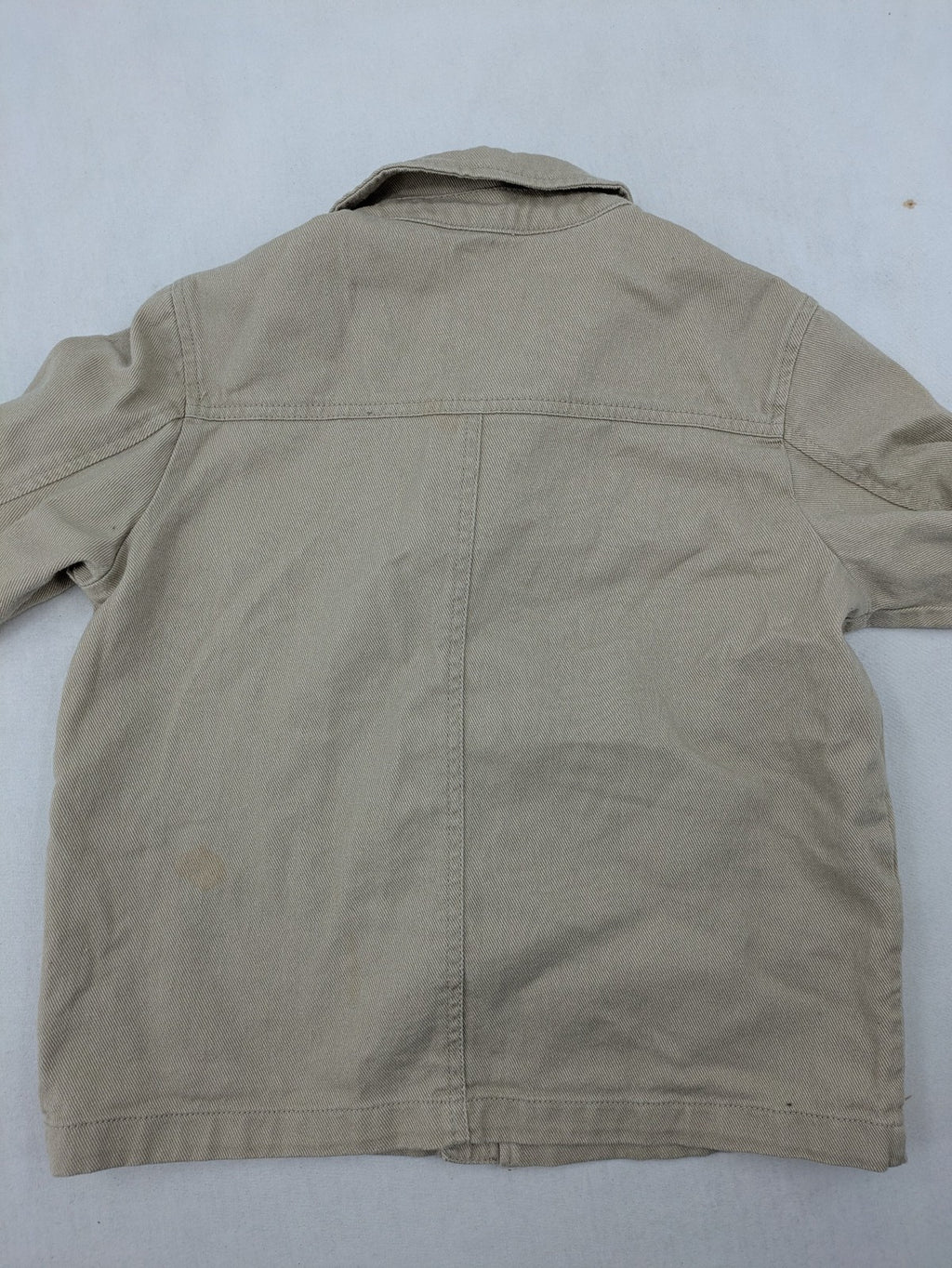 H&M beige twill coat with full zip, classic collar, and practical pockets.