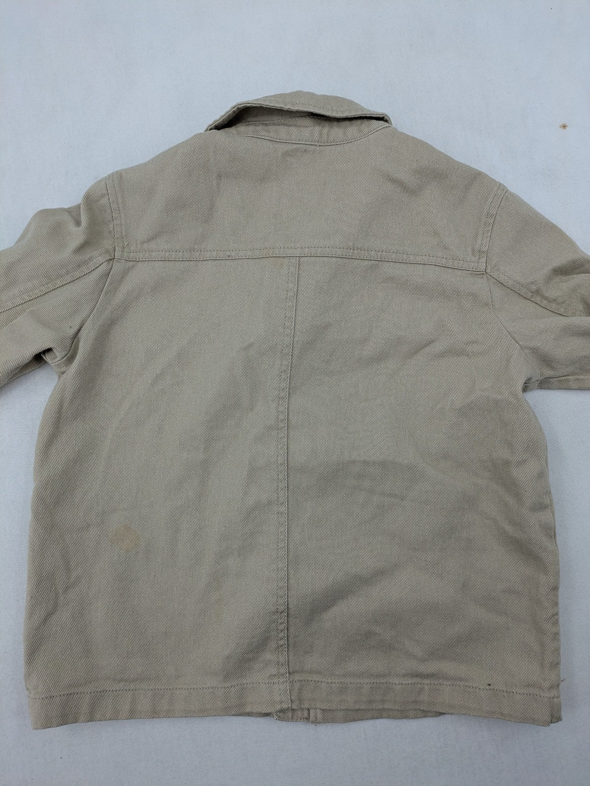 H&M beige twill coat with full zip, classic collar, and practical pockets.