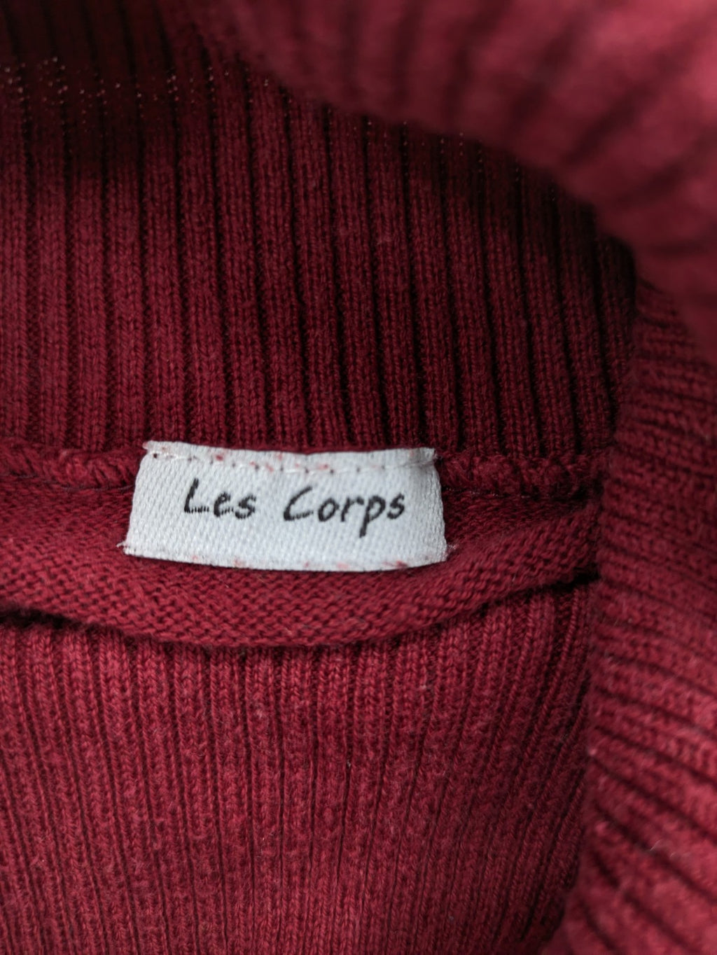 Les Corps burgundy turtle neck jumper with ribbed details and soft cotton blend material.
