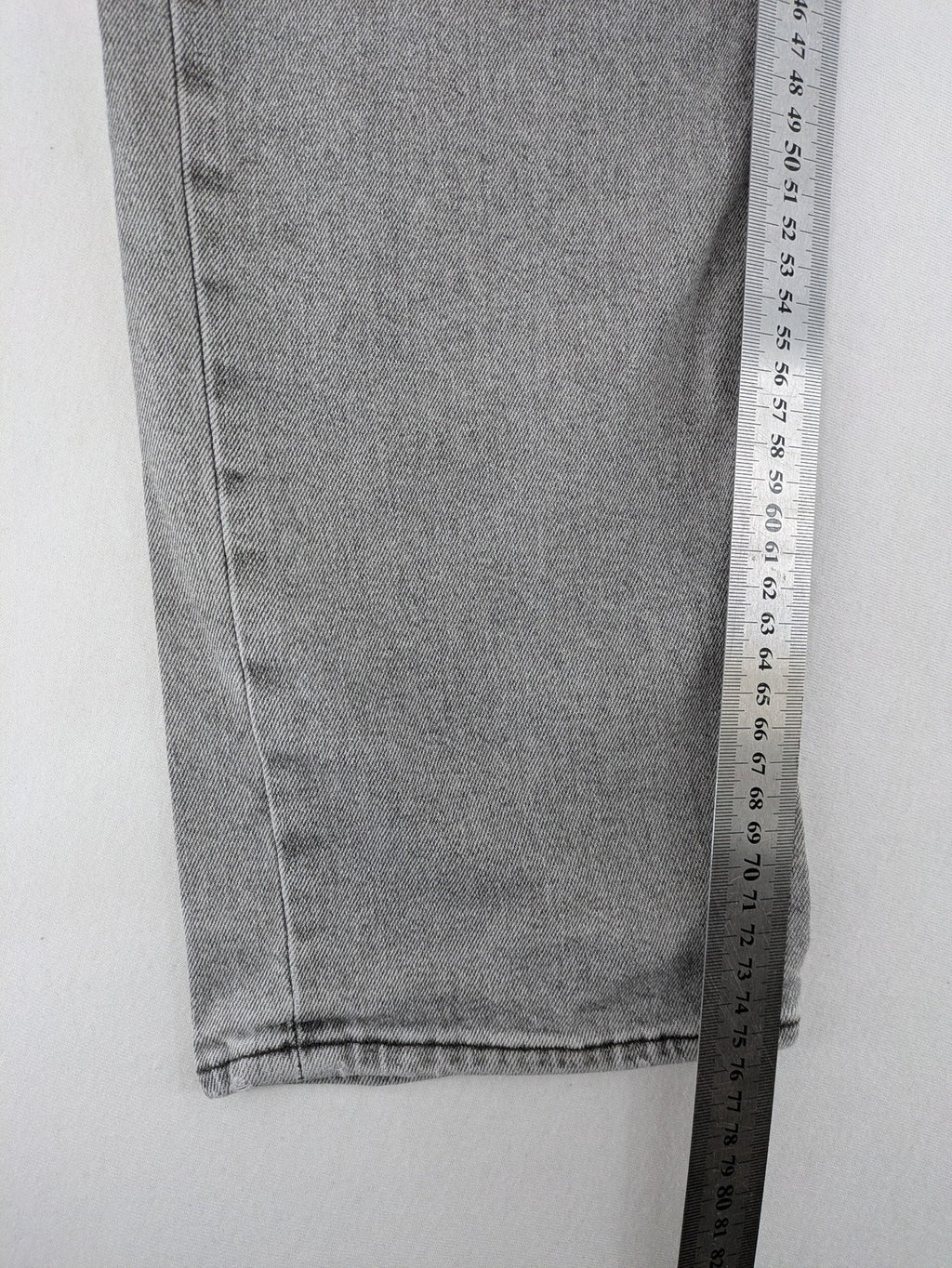 Levi's grey slim fit jeans with distressed knee details and classic logo patch.