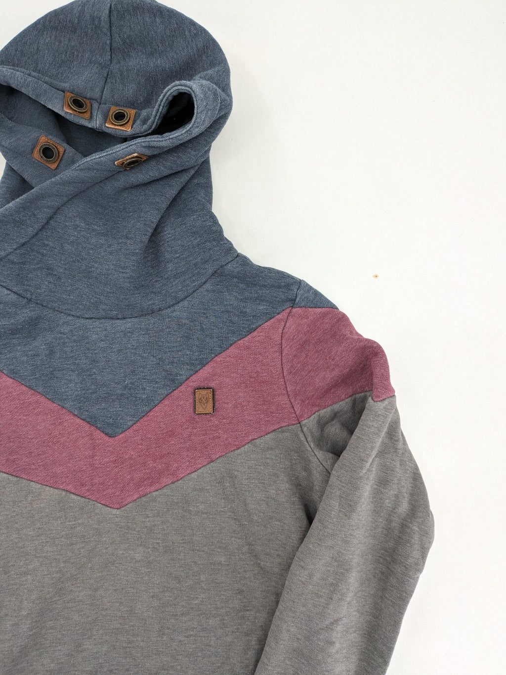 Naketano multicolor turtle neck jumper with button placket and anchor patches.
