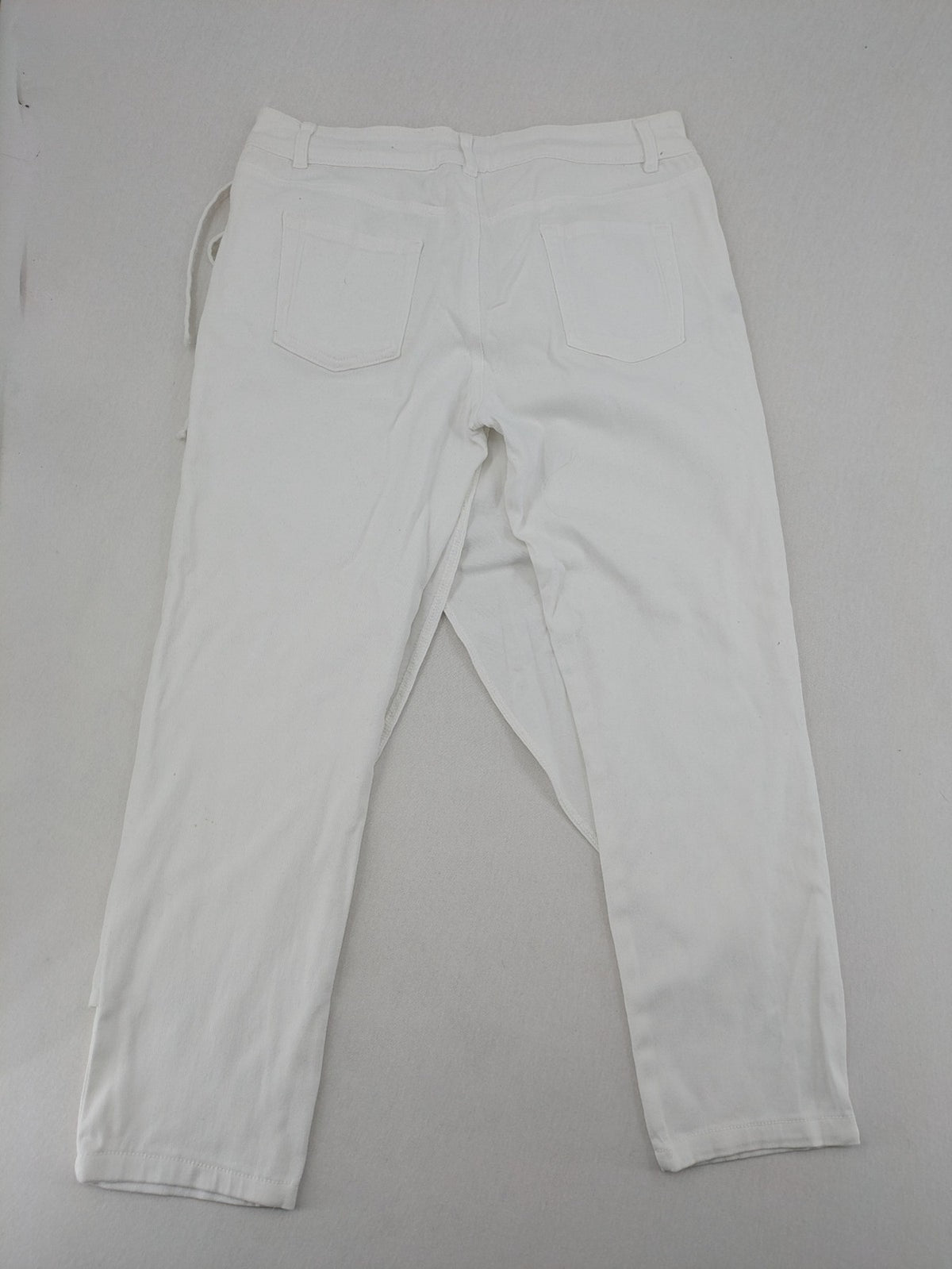 New Collection white straight jeans asymmetrical wrap design with side lacing and cotton-stretch material.