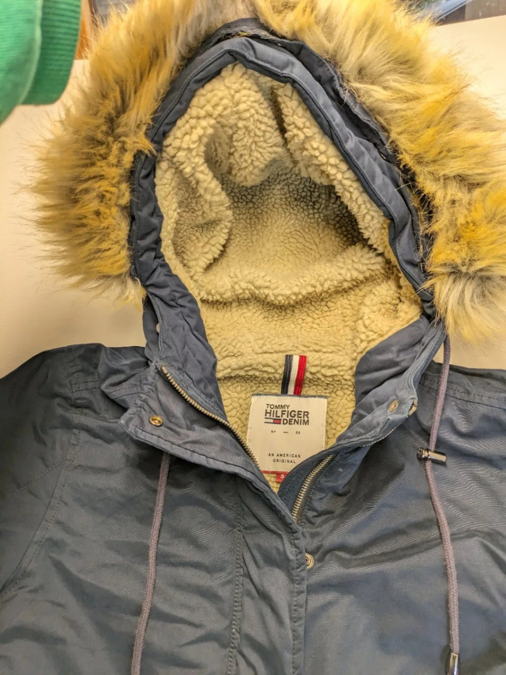 Tommy Hilfiger Denim blue parka coat with faux fur hood and Sherpa lining.