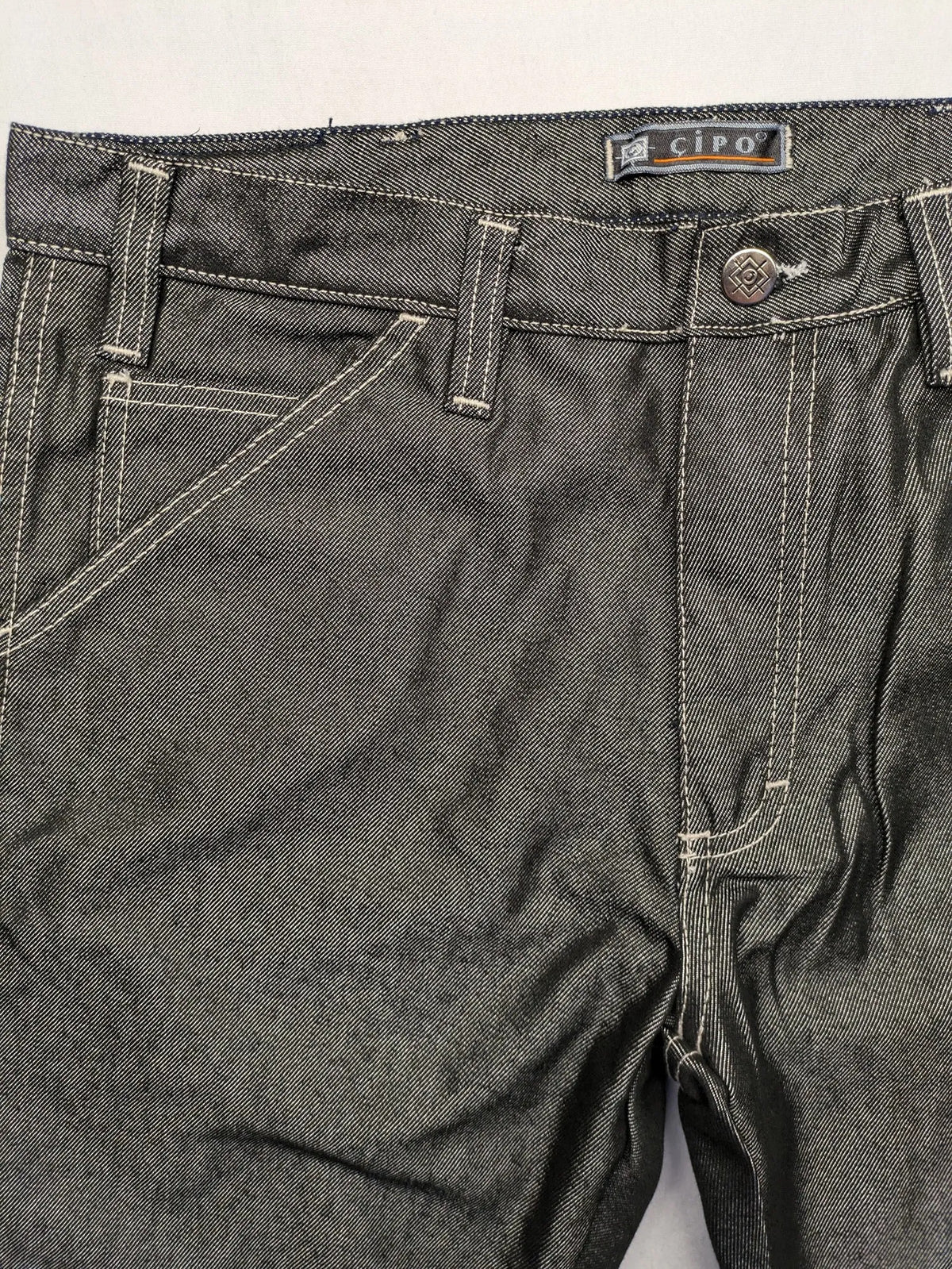 CIPO grey bootcut biker jeans with white contrast stitching and moto-inspired knee pleats.