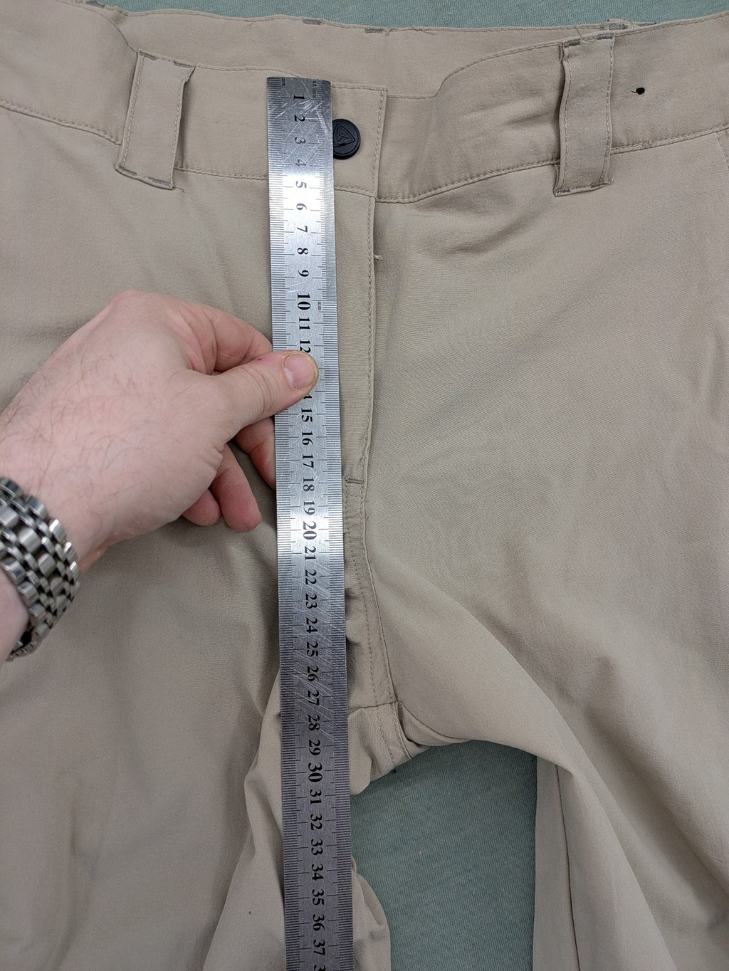 Hickory beige outdoor pants with multiple zippered pockets and stretch fabric for comfort.