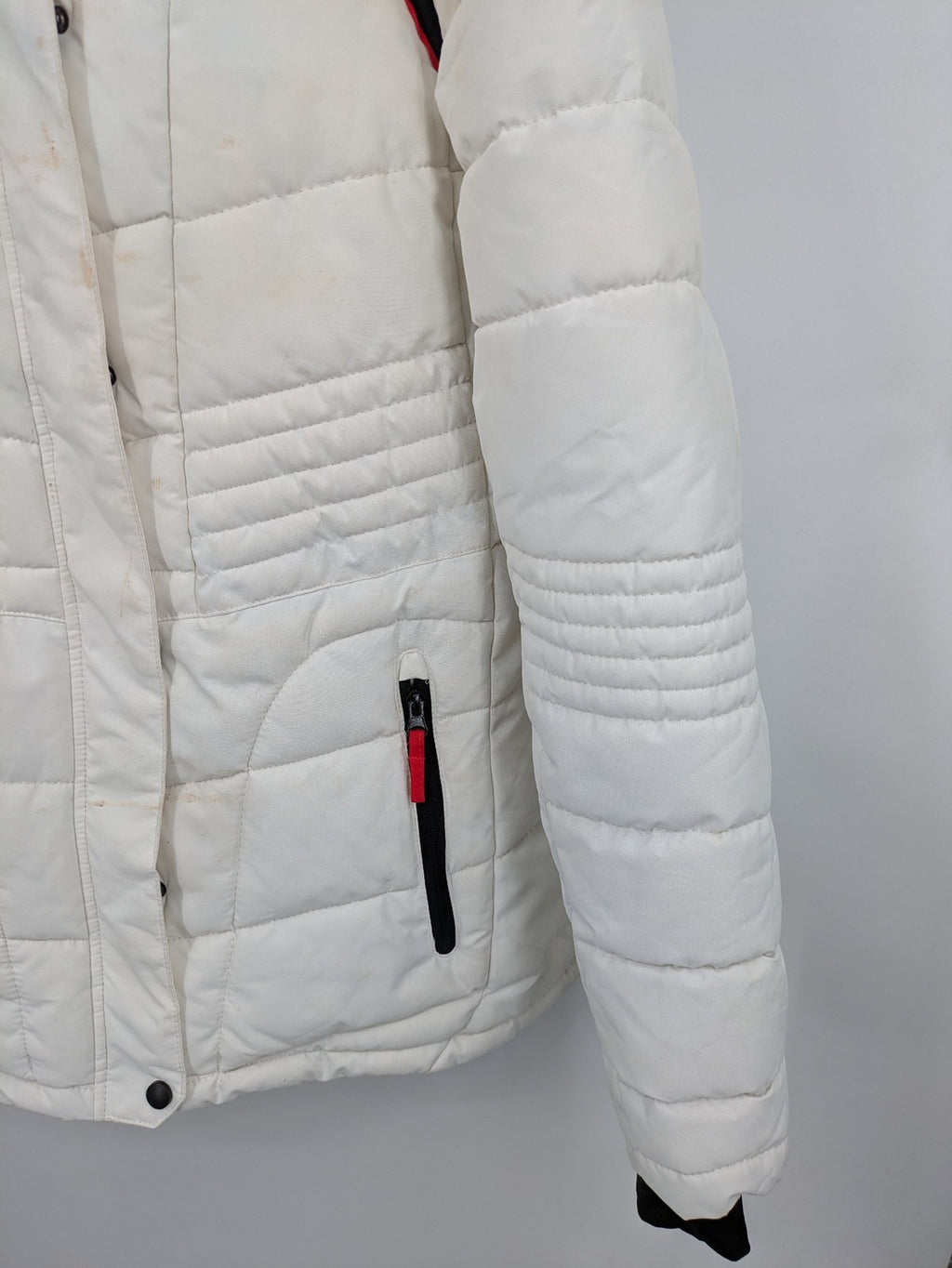 Janina white puffer jacket with quilted design and faux fur hood accents.