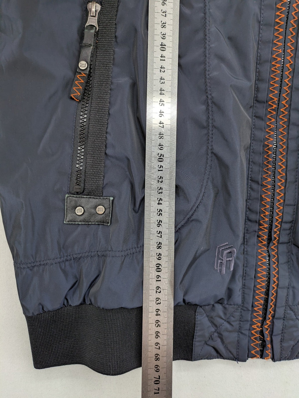Radloff grey navy bomber jacket with orange contrast stitching and zippered pockets.