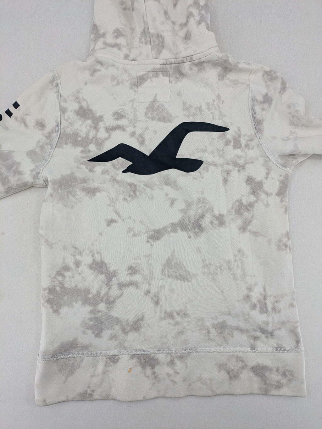 Hollister grey and white tie-dye hoodie with logo on chest, back, and sleeve.