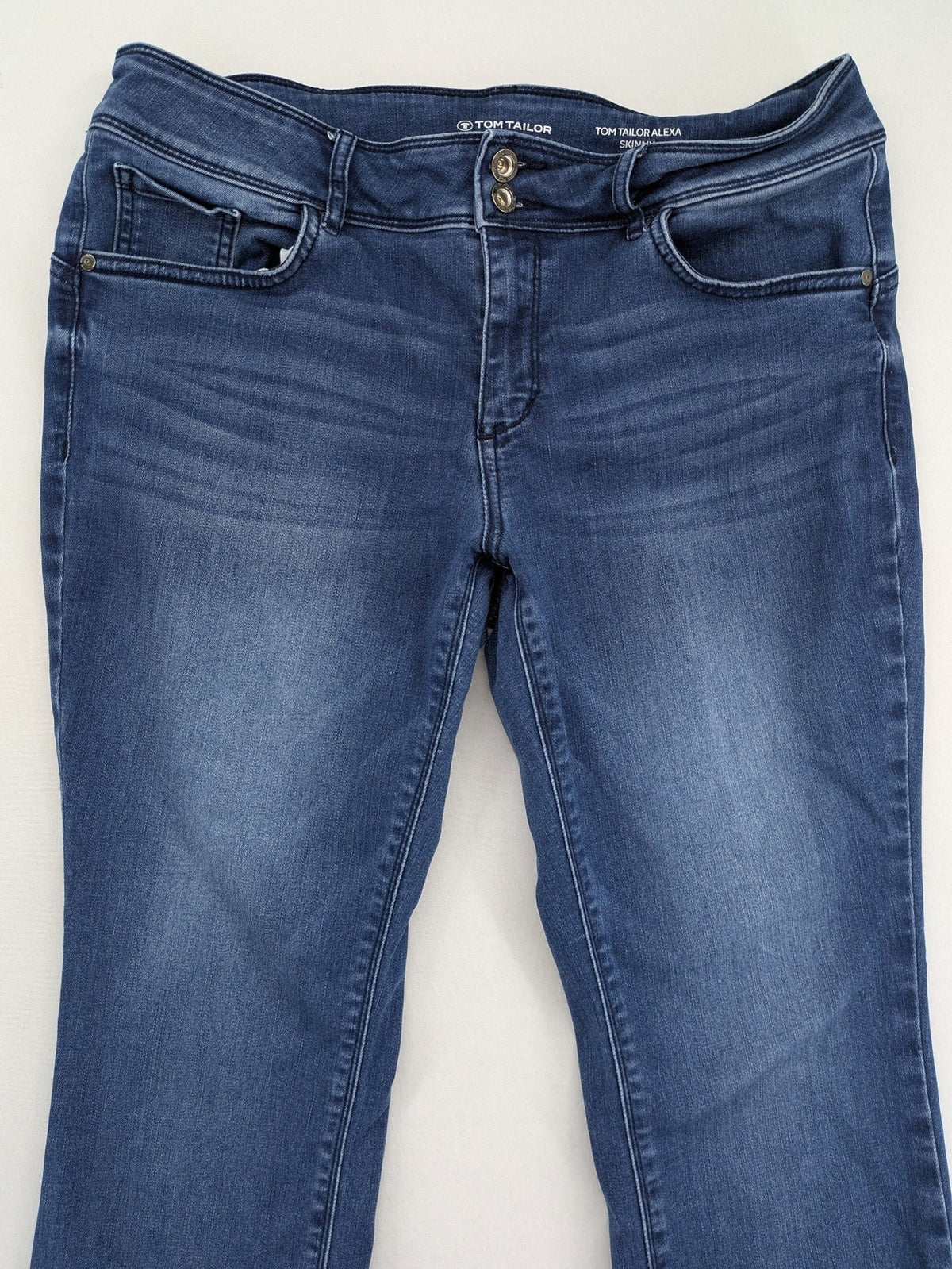Tom Tailor blue skinny jeans with classic 5-pocket design and double button closure.