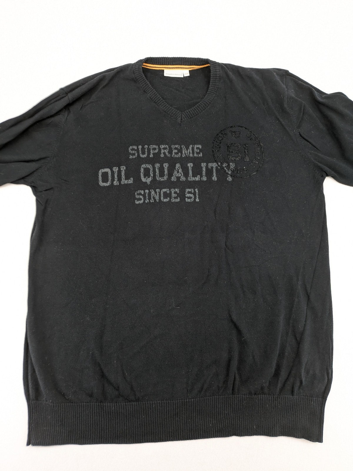 Angelo Litrico black knit jumper V-neck with tonal emblem and "Supreme Oil Quality" graphic.