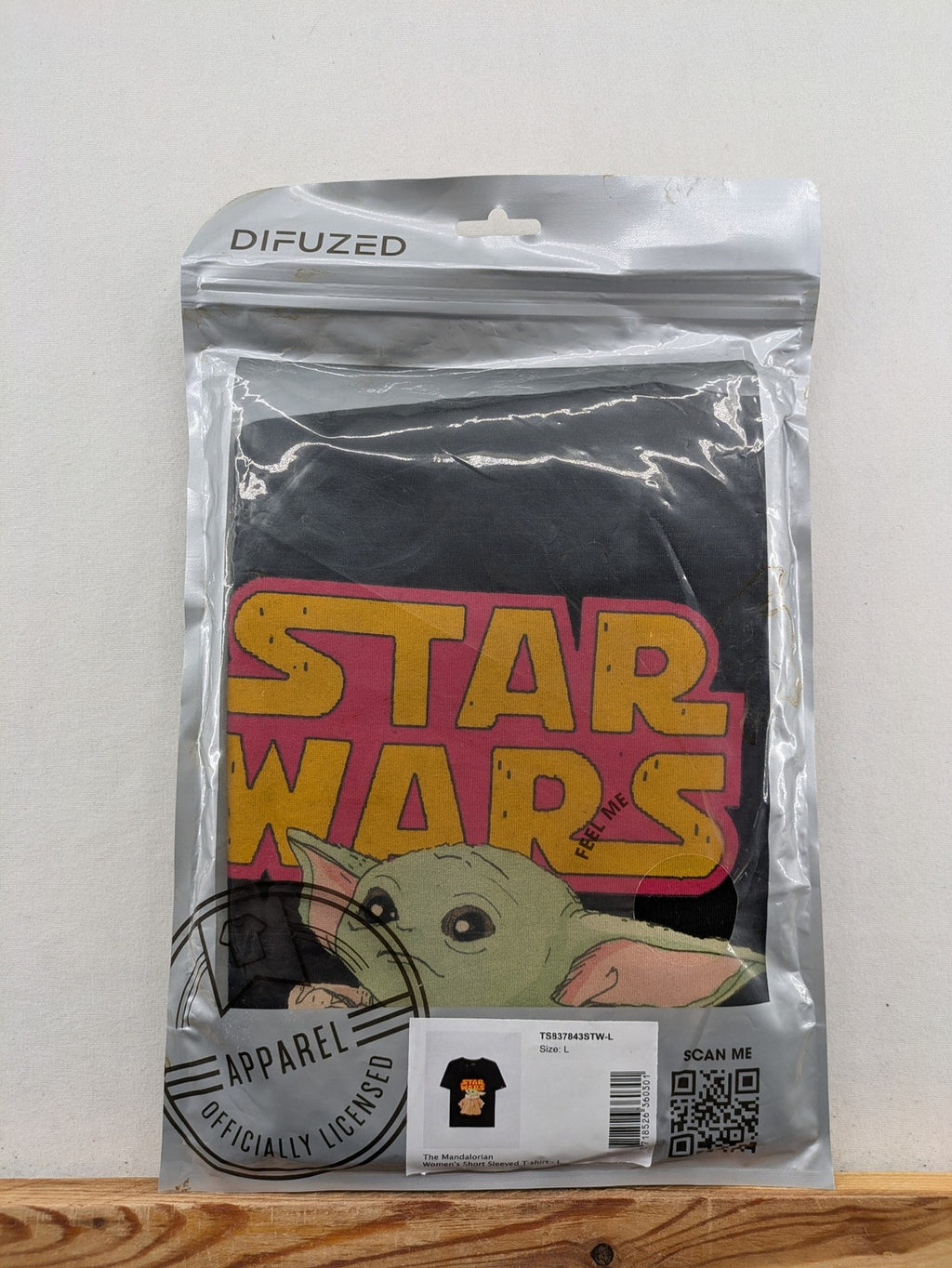 Star Wars black t-shirt featuring colorful Grogu graphic and short sleeves.