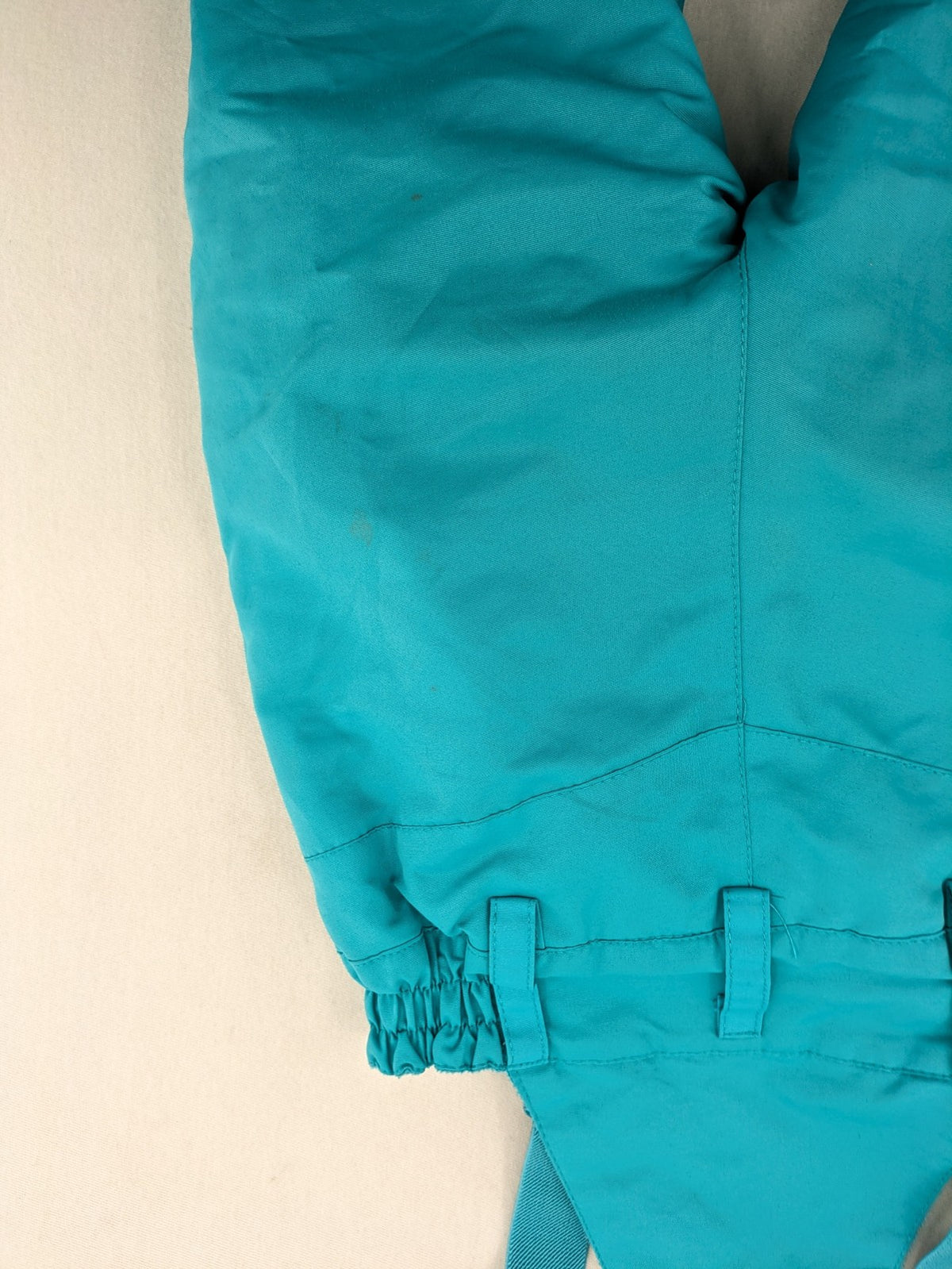 Topolino blue and turquoise snow pants with adjustable straps and fleece-lined bib.