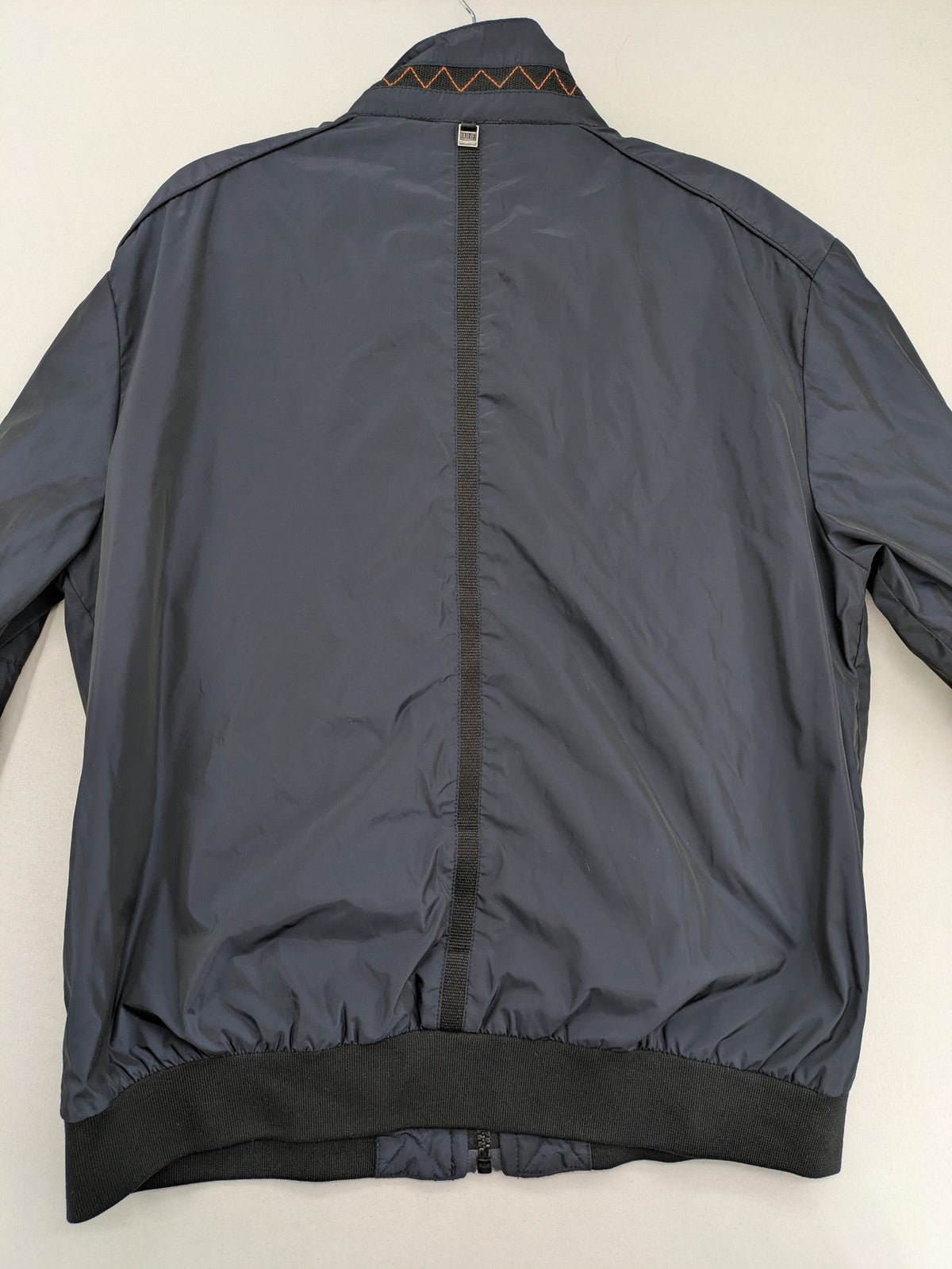 Radloff grey navy bomber jacket with orange contrast stitching and zippered pockets.