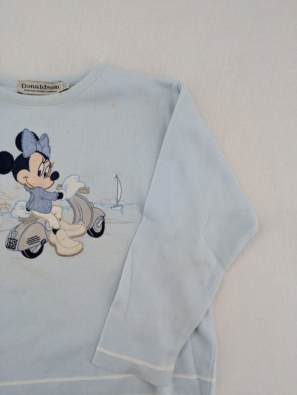 Donaldson multi turtle neck jumper light blue with embroidered Minnie Mouse graphic and ribbed texture.