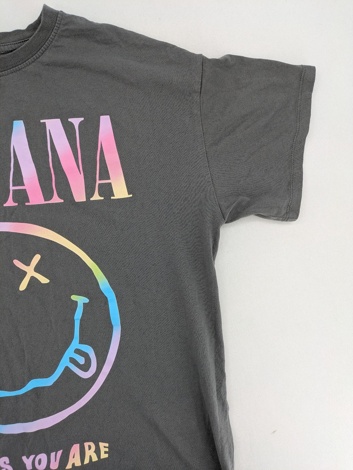 Nirvana grey t-shirt with rainbow Smiley logo and "Come As You Are" text.