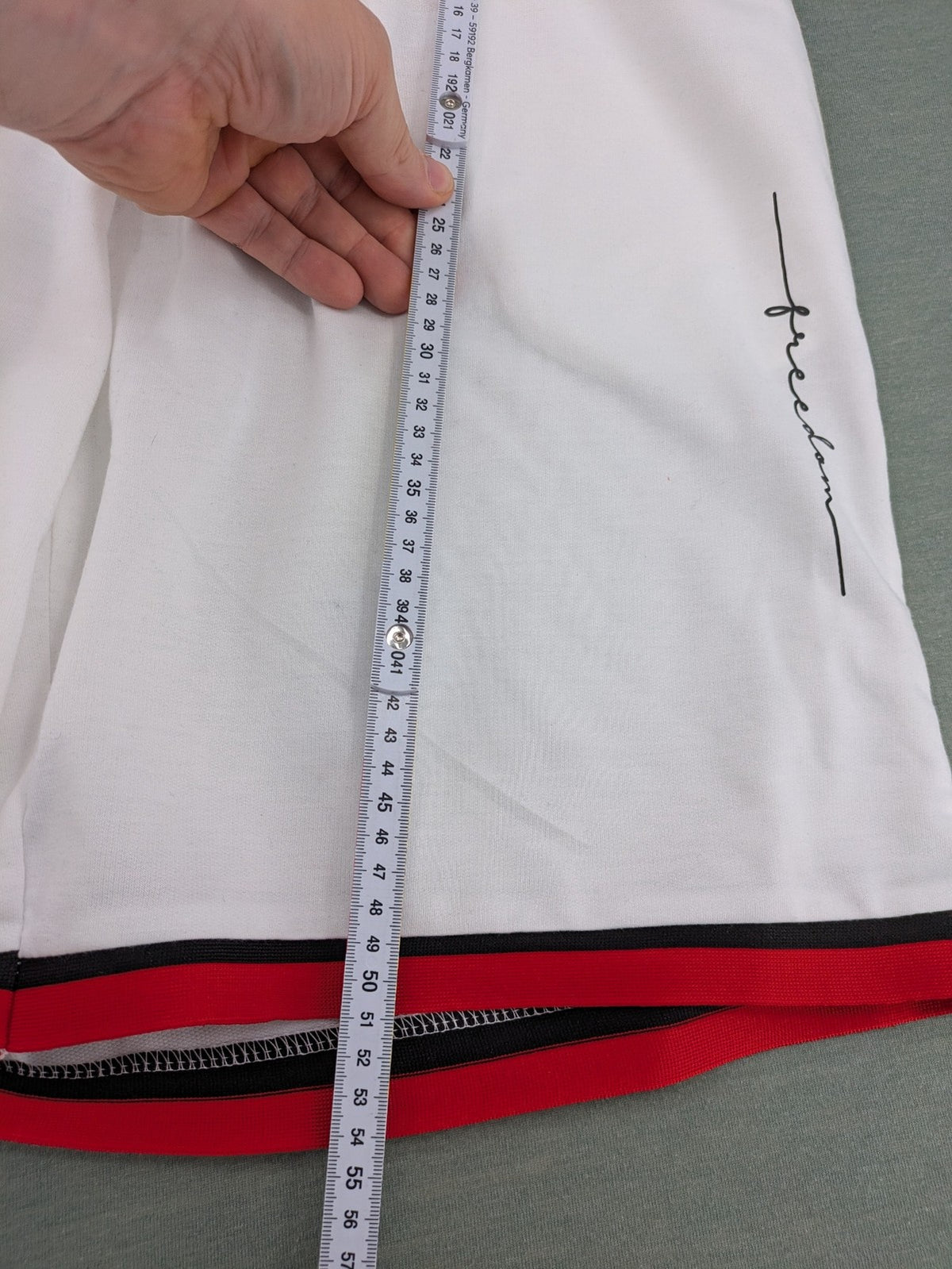 Manfinity black and white outfit set with red accents and "Freedom" graphic print.