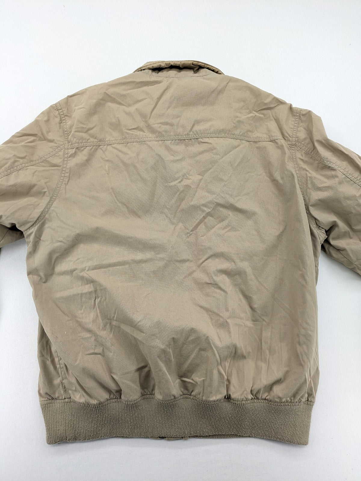 Canda beige bomber jacket full zip with ribbed collar and buttoned chest pockets.