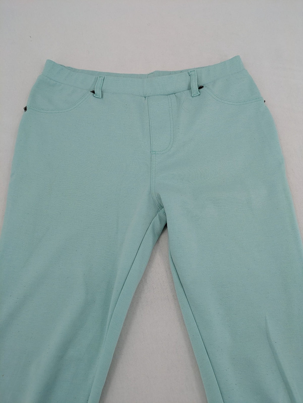 Dito green treggings with pull-on design, front pockets, and belt loops.