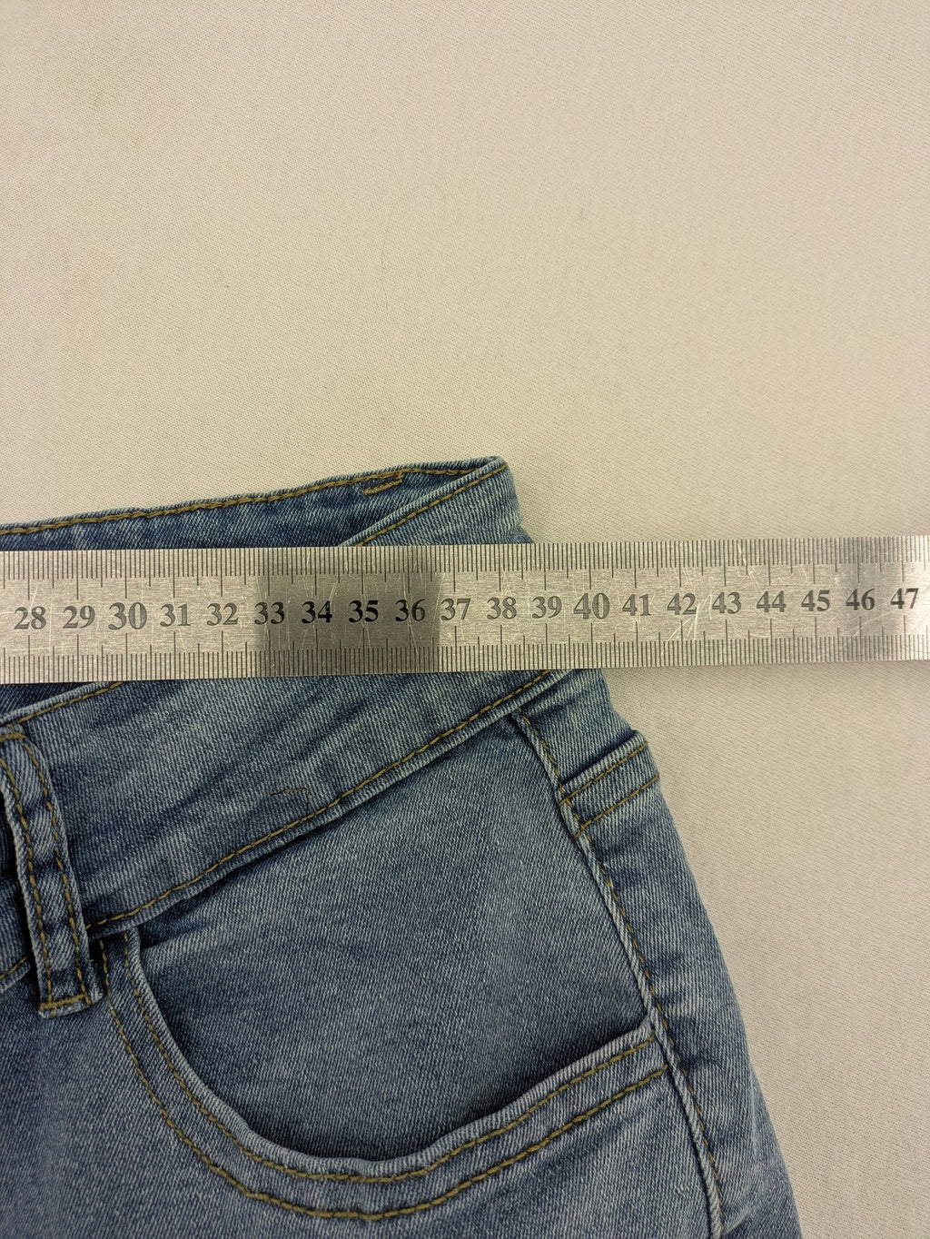 C&A blue bootcut jeans high waist stretch denim with double button closure.
