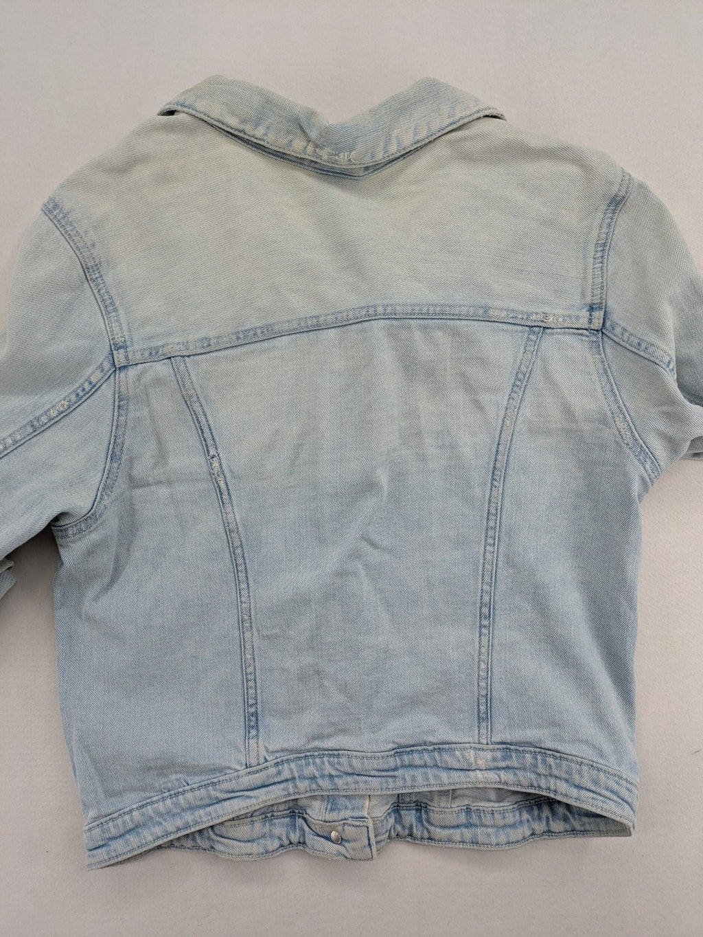 H&M denim jacket light blue classic trucker style with button placket and chest pockets.
