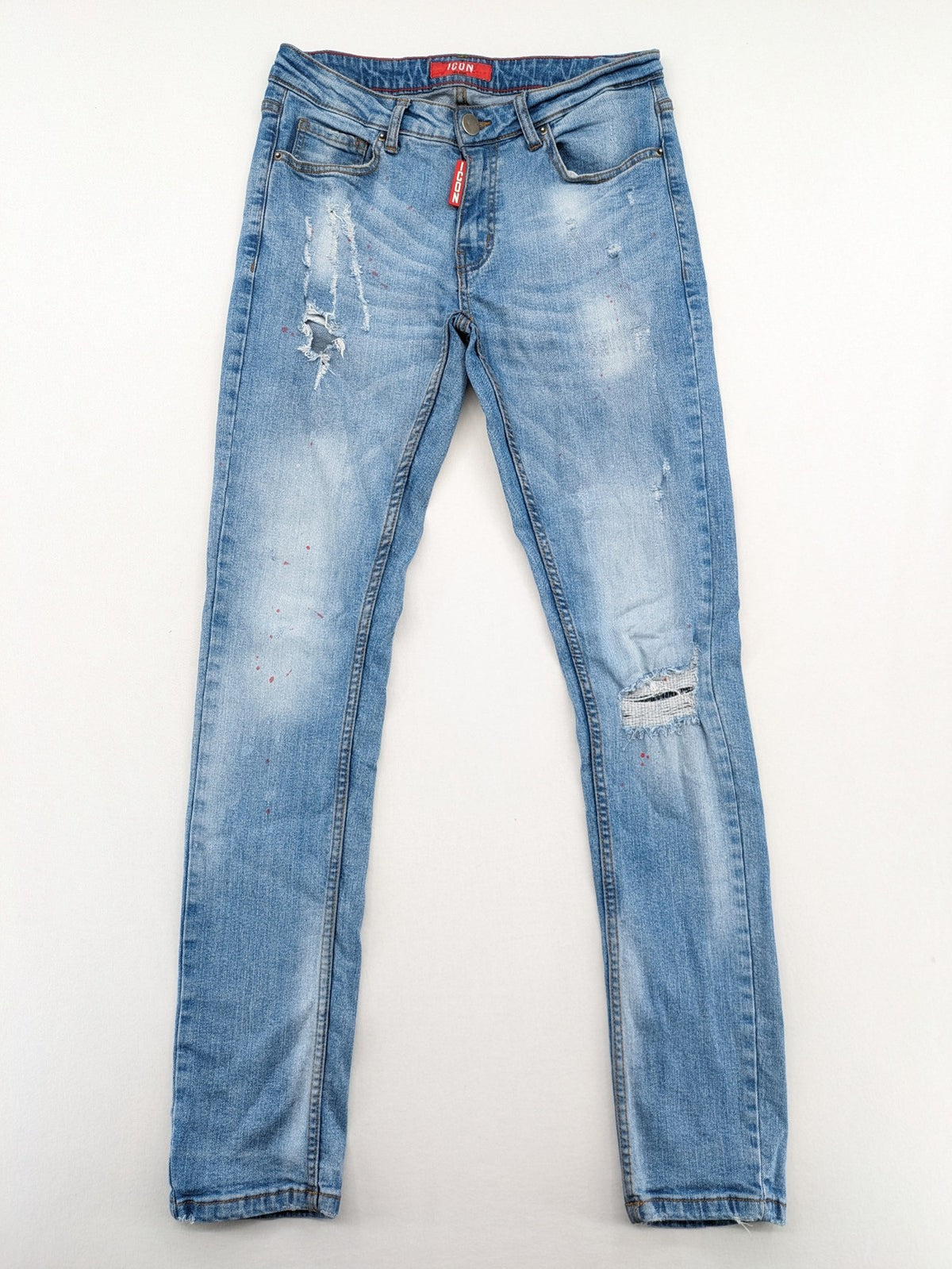 Milano straight jeans light blue distressed with red splatter and extra slim fit.