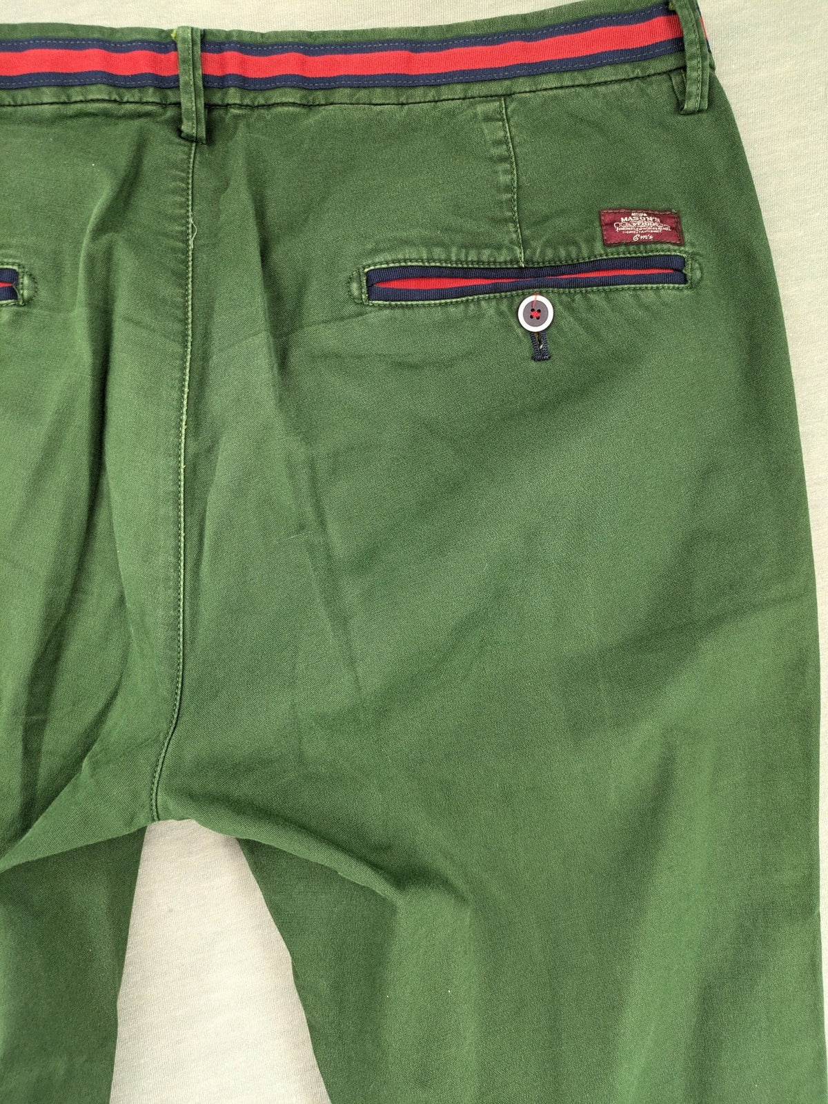 Mason's green chino pants with striped red and blue waistband, cotton stretch material.
