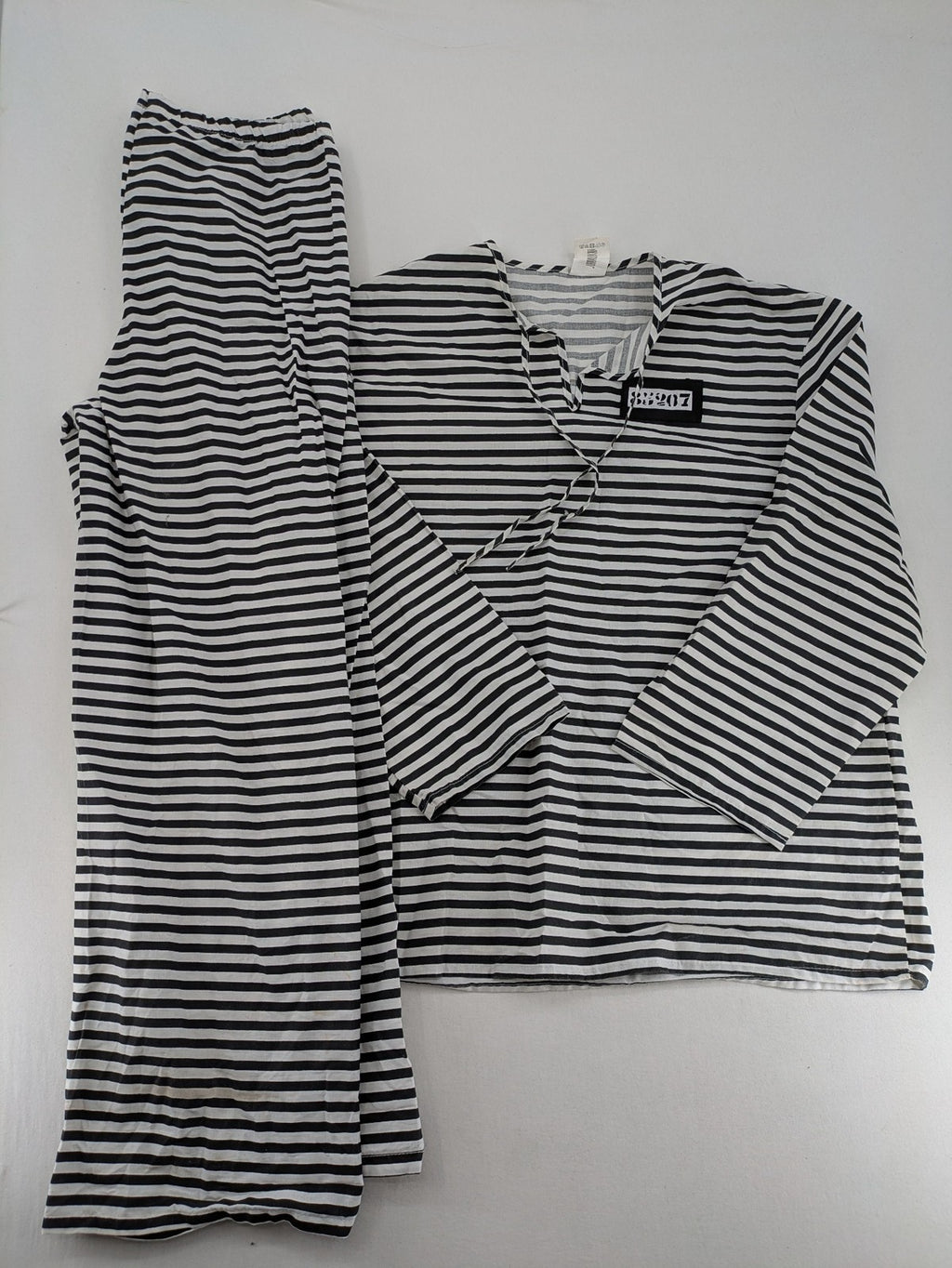 Rubie's costume set black and white striped with prisoner number patch on chest.