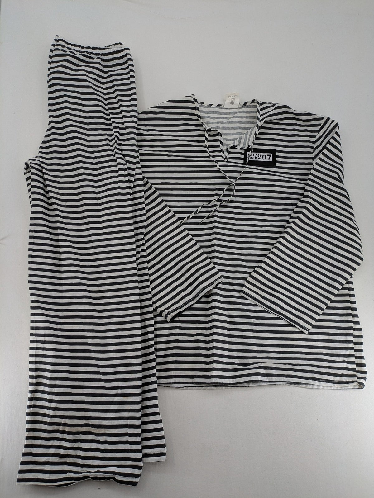 Rubie's costume set black and white striped with prisoner number patch on chest.