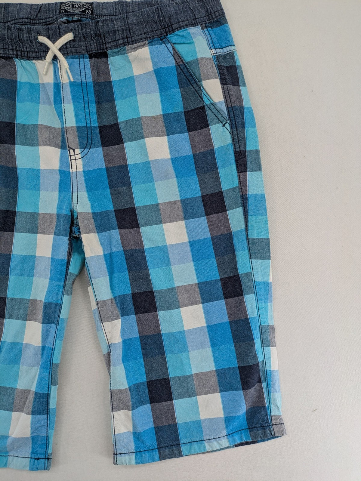 C&A blue checkered shorts with elastic waistband and side pockets, Skate Nation style.