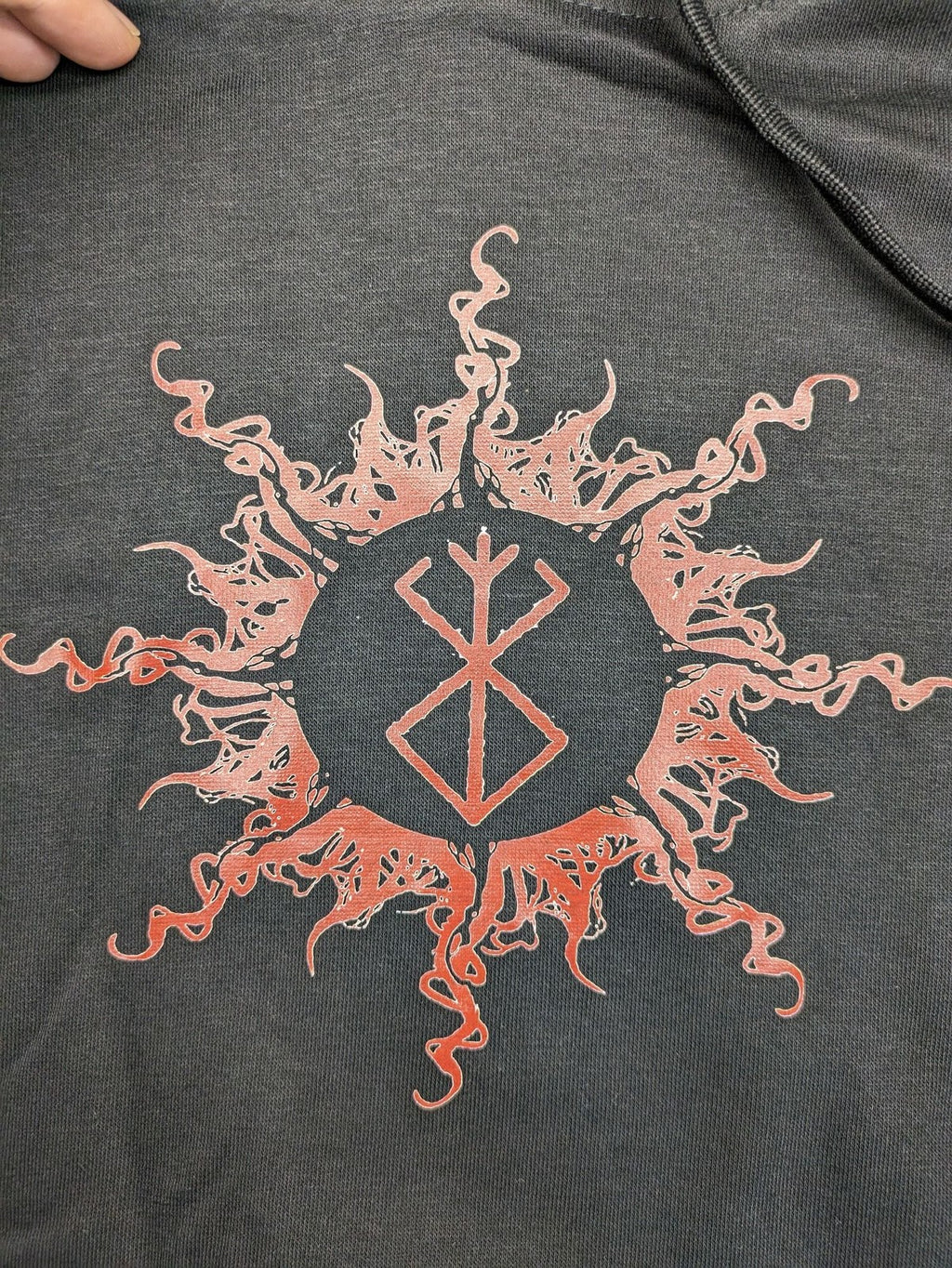 Berserk grey hoodie with pink "Brand of Sacrifice" symbol on front and back.