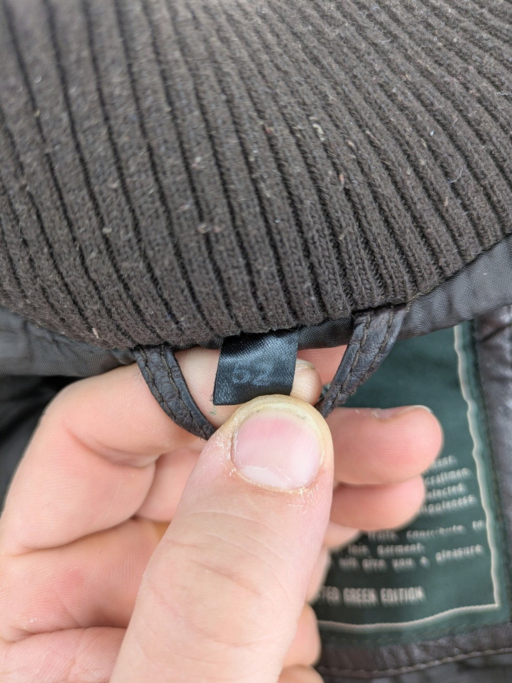 H&M green leather bomber jacket with ribbed collar and moto-style padding.