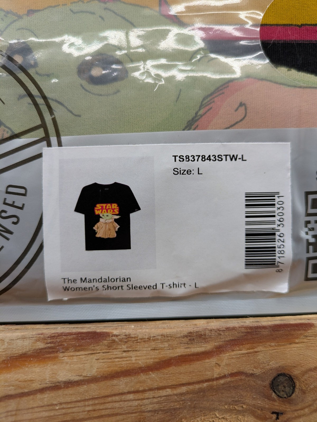 Star Wars black t-shirt featuring colorful Grogu graphic and short sleeves.