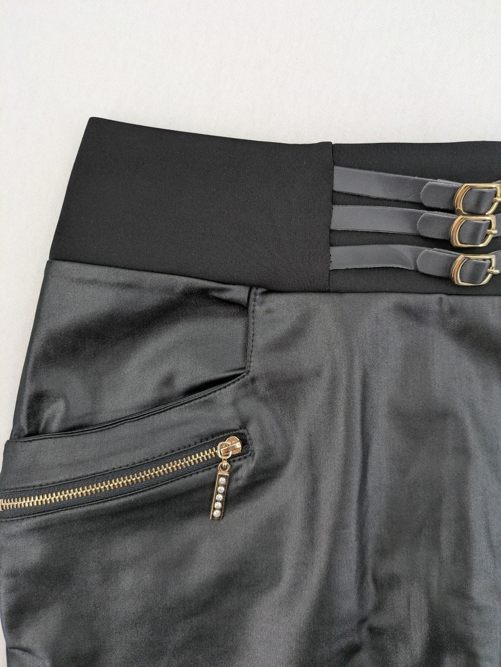 Romatie black mini bodycon skirt satin finish high waist with gold zippers and buckles.