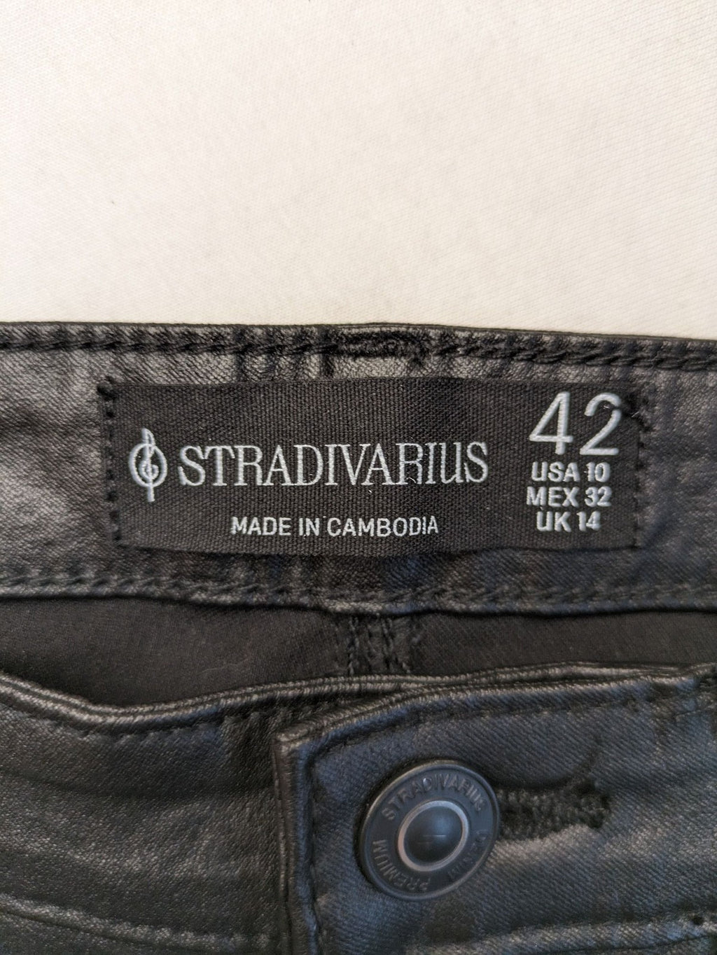 Stradivarius black coated straight jeans with leather-like finish and stretchy material.