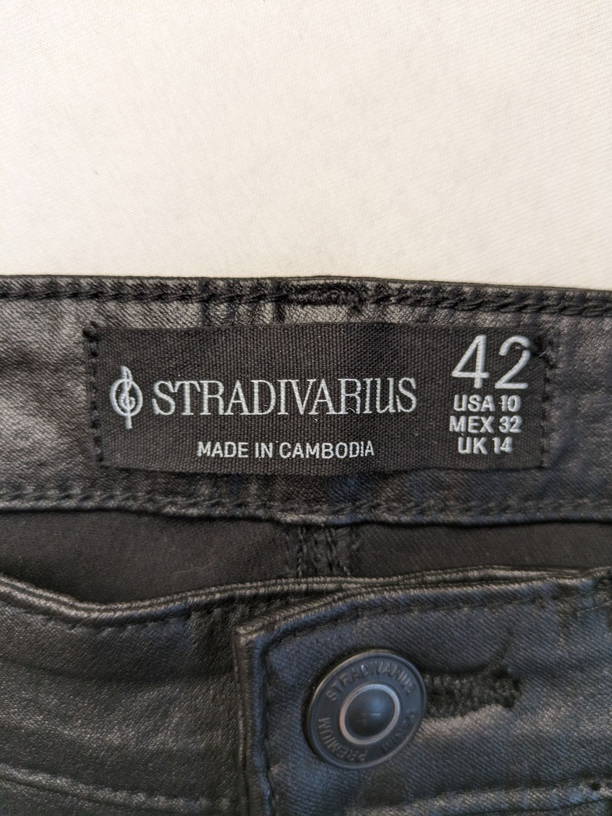 Stradivarius black coated straight jeans with leather-like finish and stretchy material.