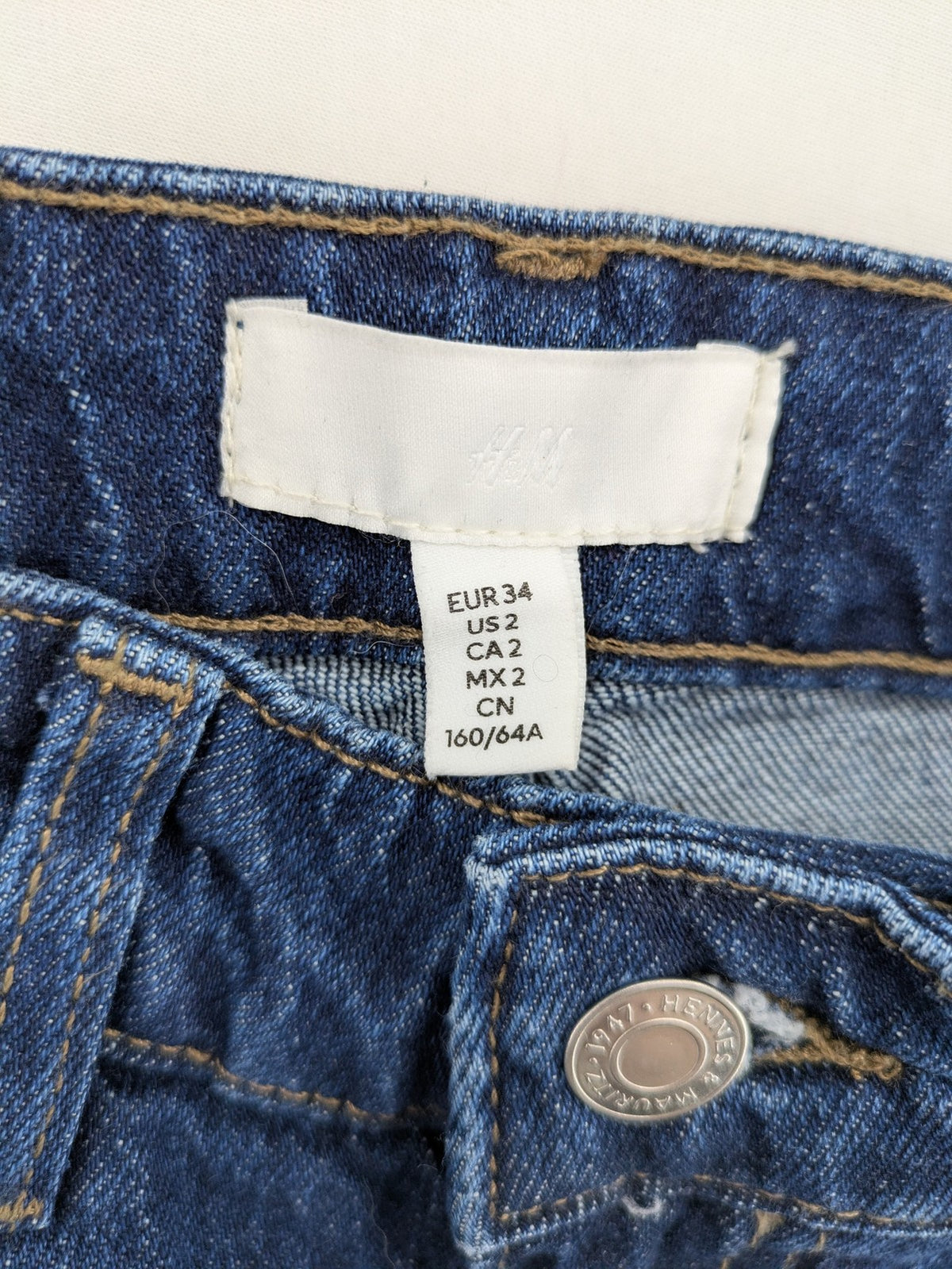 H&M blue wide leg high waist jeans with classic 5-pocket design and stretch denim.