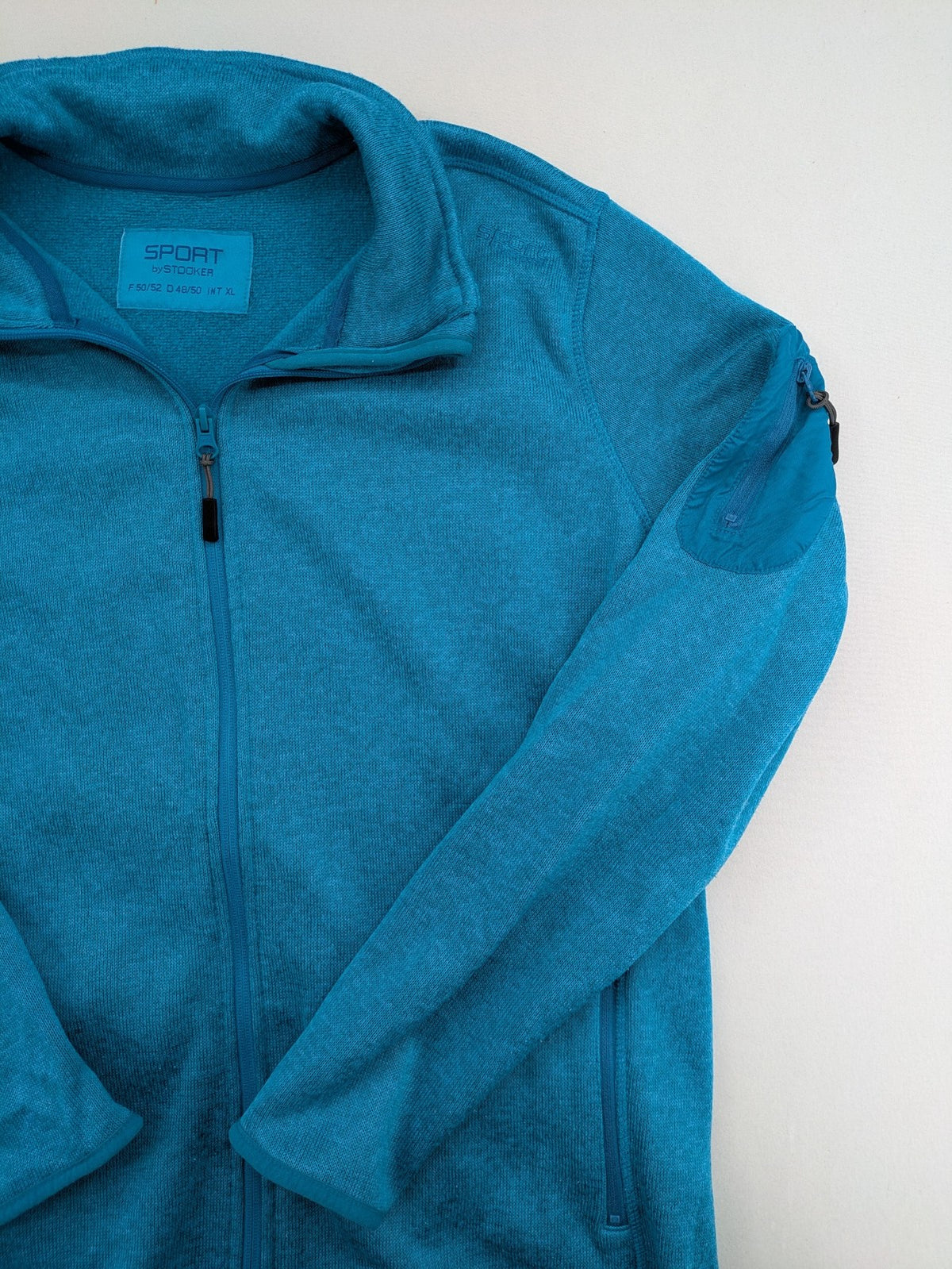 Stooker blue and turquoise fleece jacket with full zip and stand-up collar.