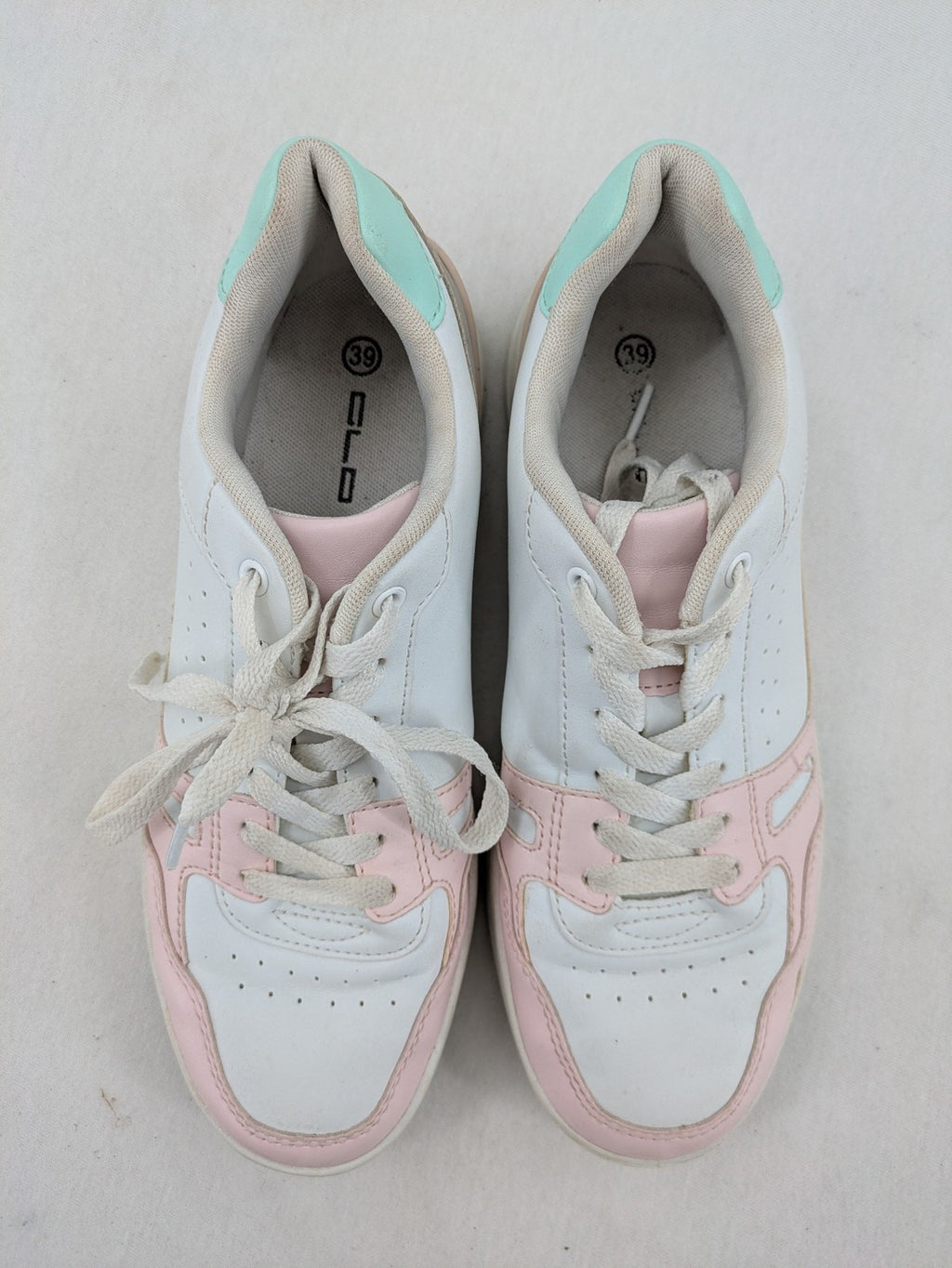 Graceland white sneakers with pink and mint green accents, low-top design, cushioned tongue.