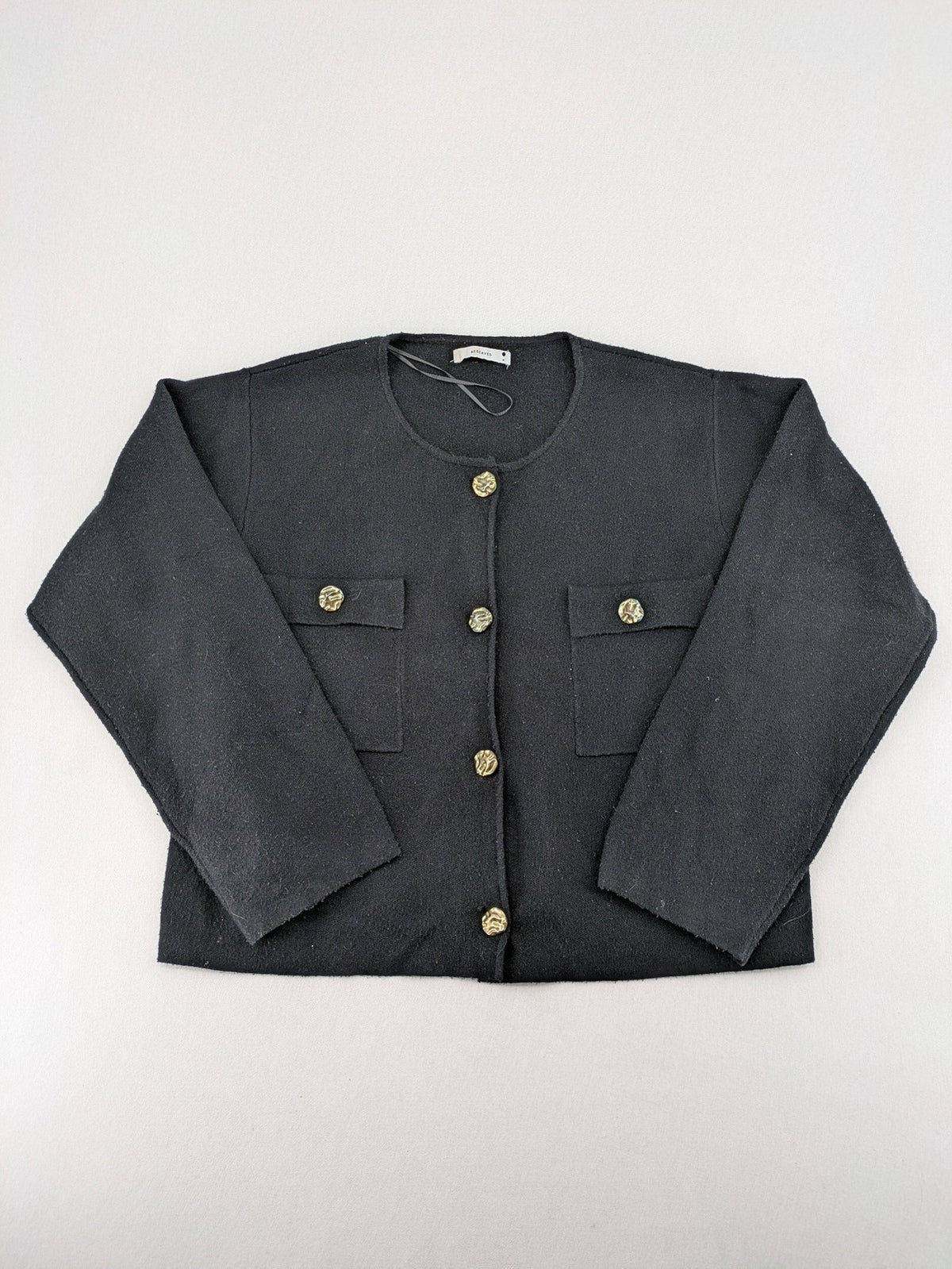 Reserved gold turtle neck jumper with black knit, gold button details and front pockets.