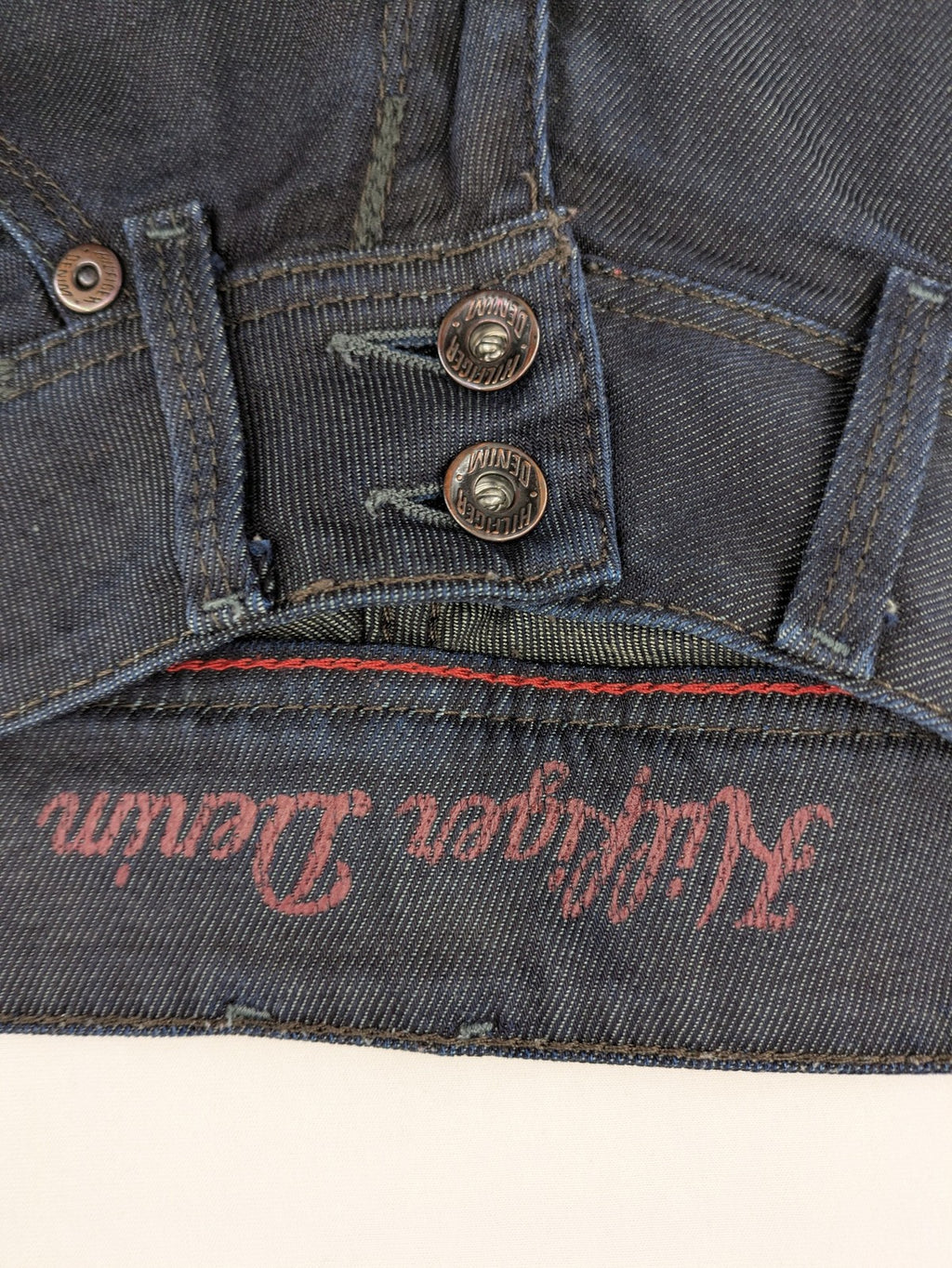 Hilfiger Denim blue straight jeans with double button closure and logo detail.