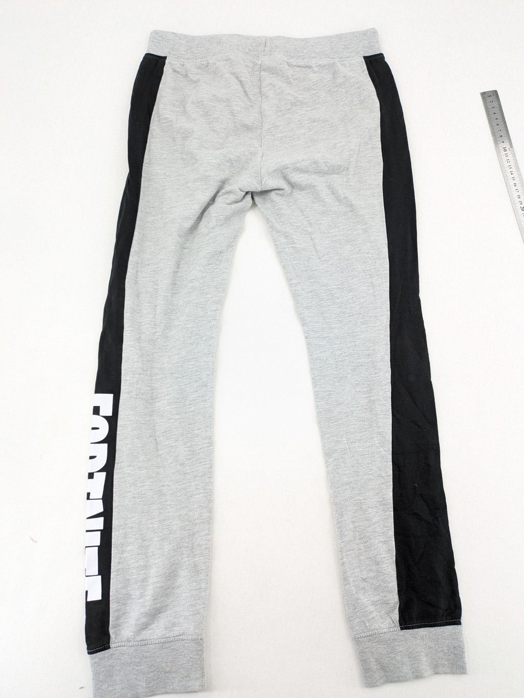Fortnite pants grey with black side stripes and large logo print, cotton blend material.
