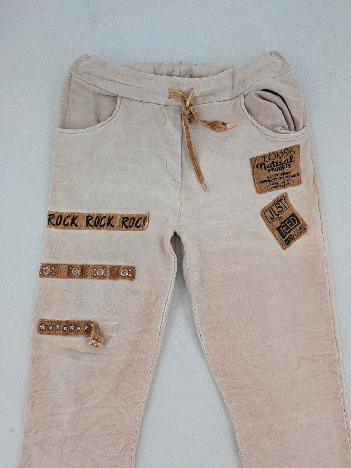 Made In Italy beige pants with crinkle texture and rock-style patches, drawstring waist.
