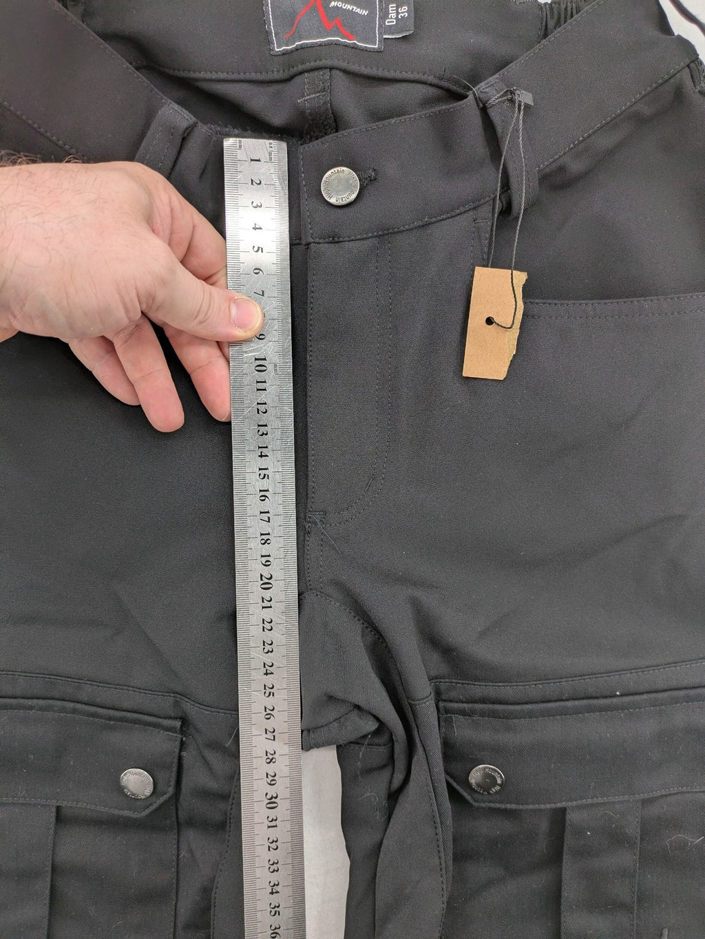 High Mountain black cargo pants with multiple pockets and durable stretch material.