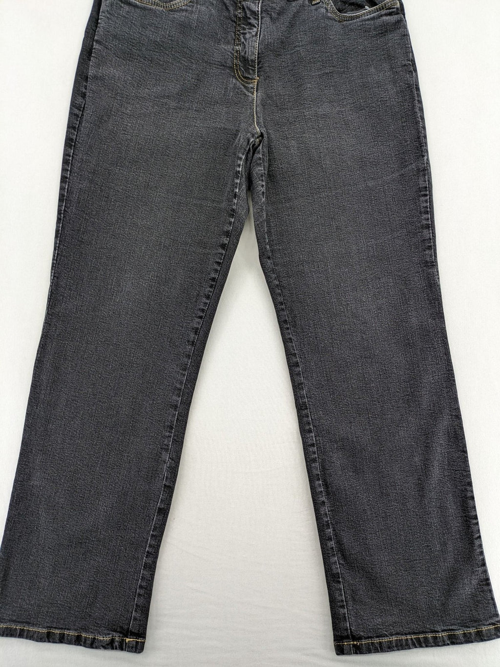 Bootcut grey low rise bootcut jeans five-pocket design with zipper and button closure.