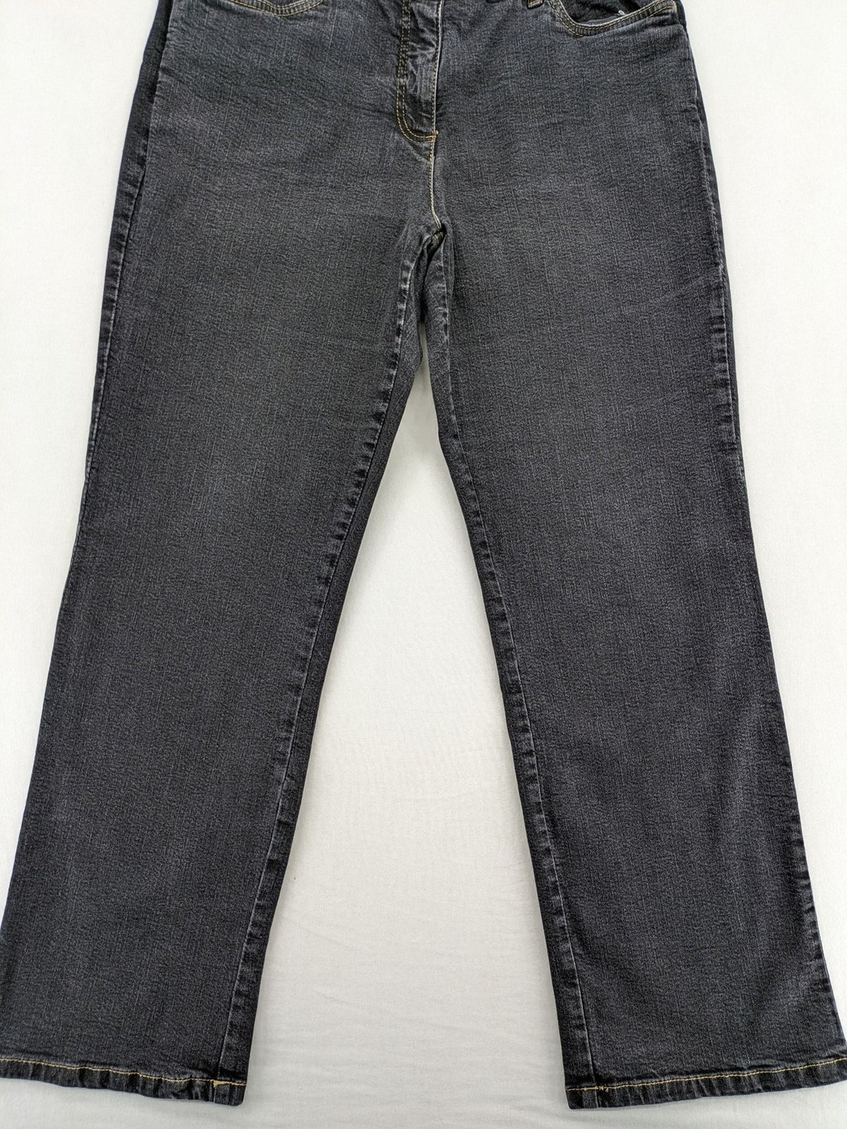 Bootcut grey low rise bootcut jeans five-pocket design with zipper and button closure.