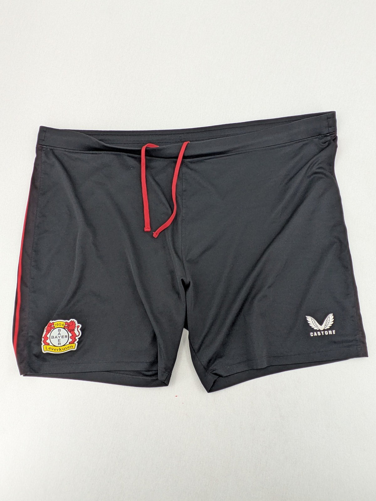 Bayer black training shorts with red side stripes, embroidered team crest and Castore logo.